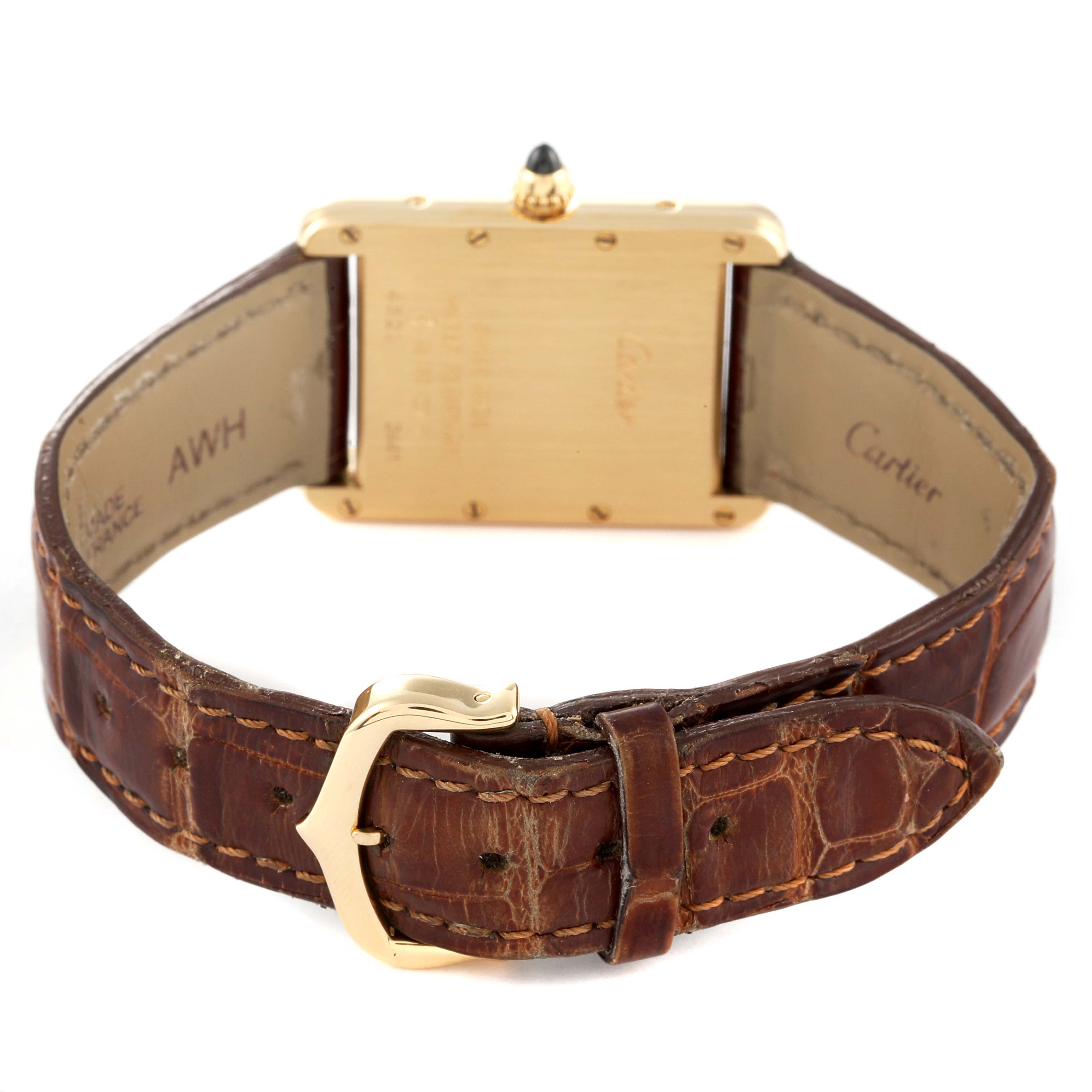 This image shows the back view of the Cartier Tank Louis W1529756 Men's Yellow Gold Silver Dial W1529756 Men's Yellow Gold Silver Dial watch featuring its leather strap and clasp.