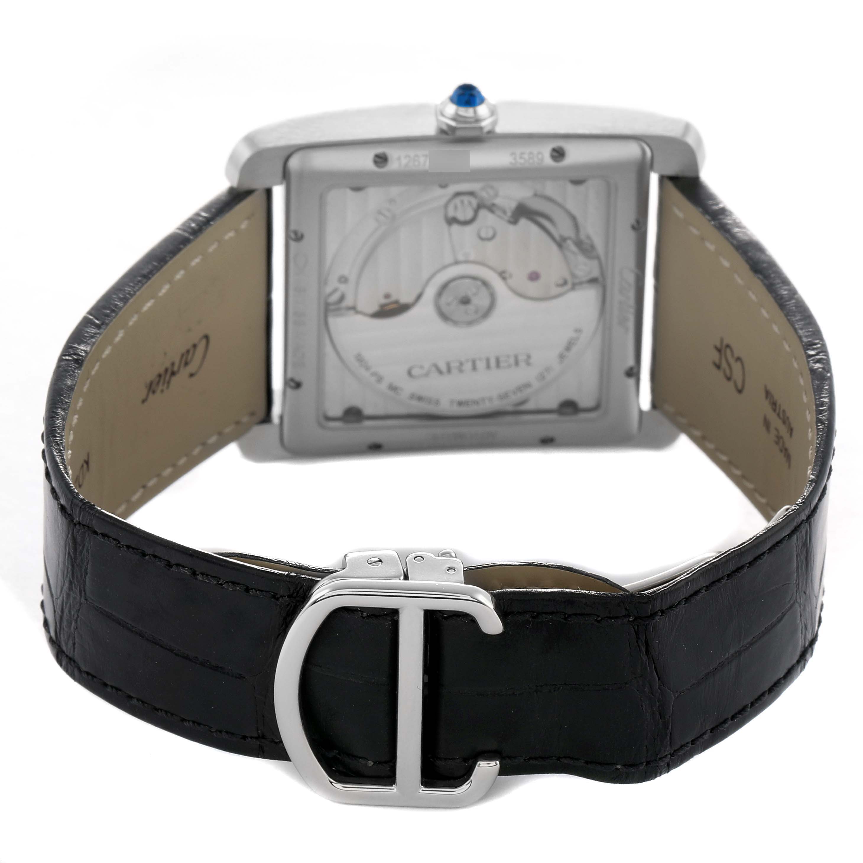 The Cartier Tank MC W5330004 Men's Stainless Steel Black Dial watch is shown from the back, revealing its movement and leather strap with a clasp.