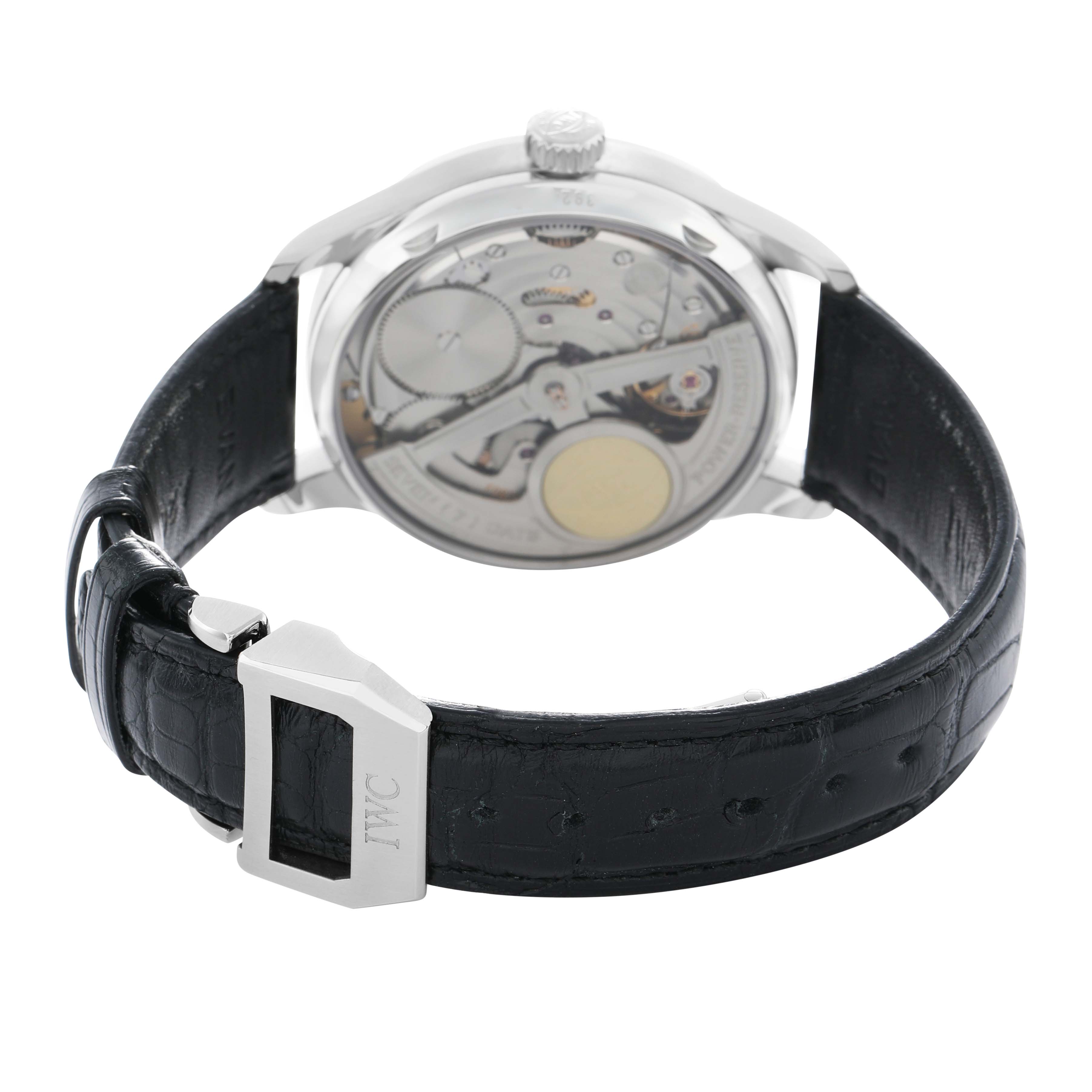The IWC Portuguese IW500114 Men's Stainless Steel Silver Dial watch is shown from the back, displaying its movement and leather strap with buckle.