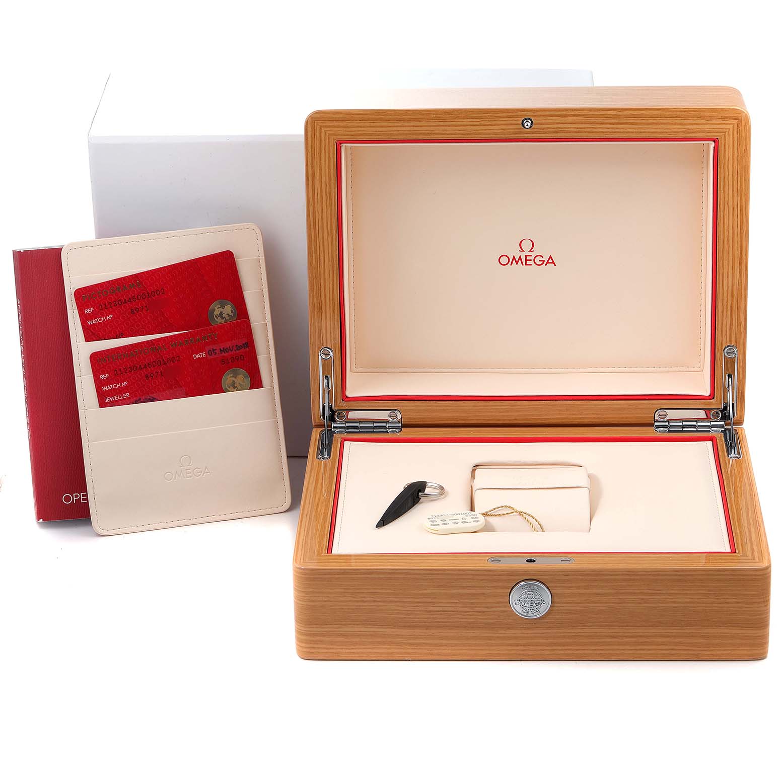 The image shows an Omega Seamaster 212.30.44.50.01.002 Men's Stainless Steel Black Dial 212.30.44.50.01.002 Men's Stainless Steel Black Dial watch's wooden box, warranty cards in a sleeve, a card holder, and a tag.