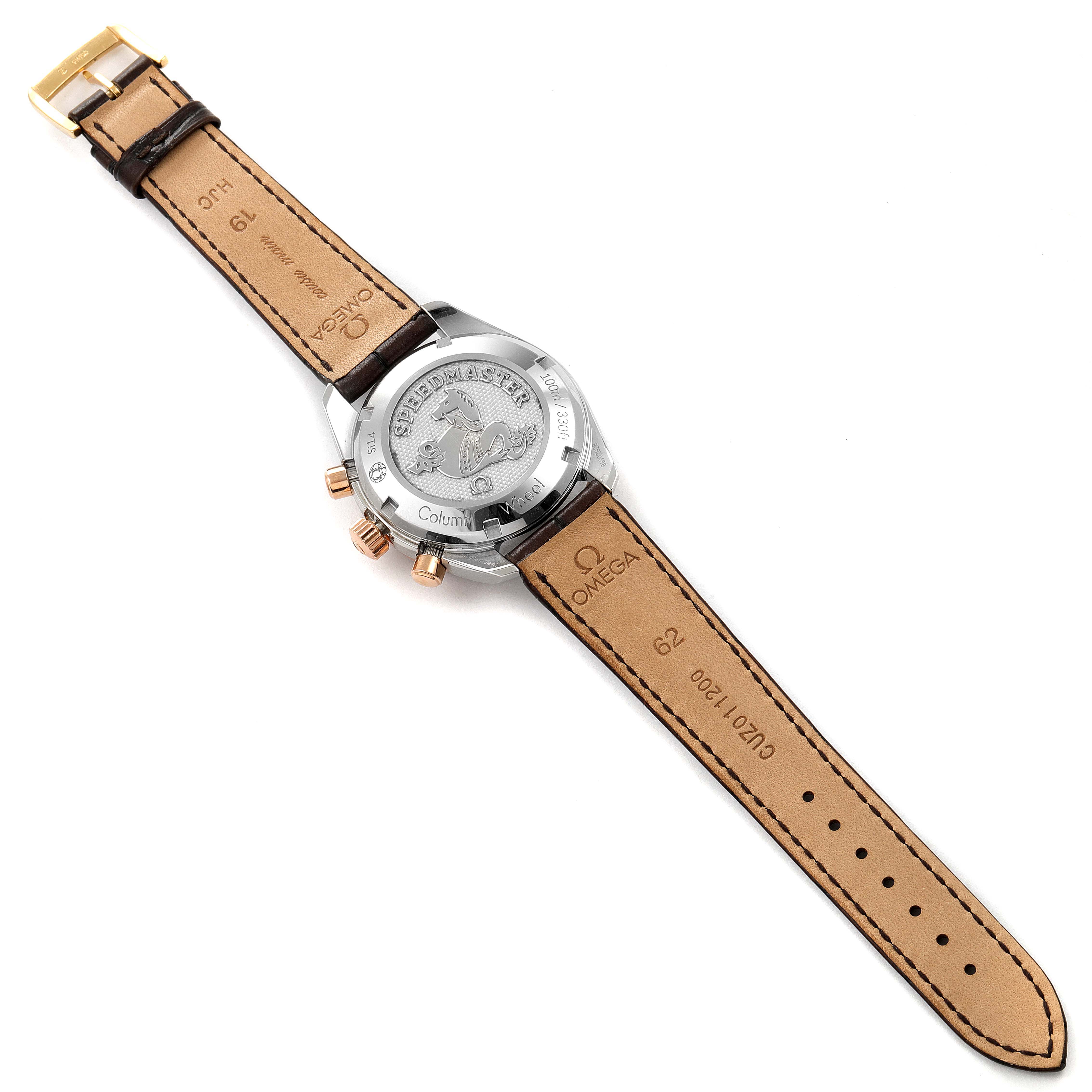 The image shows the back view of the Omega Speedmaster 324.23.38.50.02.002 Men's Steel and Gold (two tone) Silver Dial 324.23.38.50.02.002 Men's Steel and Gold (two tone) Silver Dial watch, highlighting the engraved case back and leather strap.