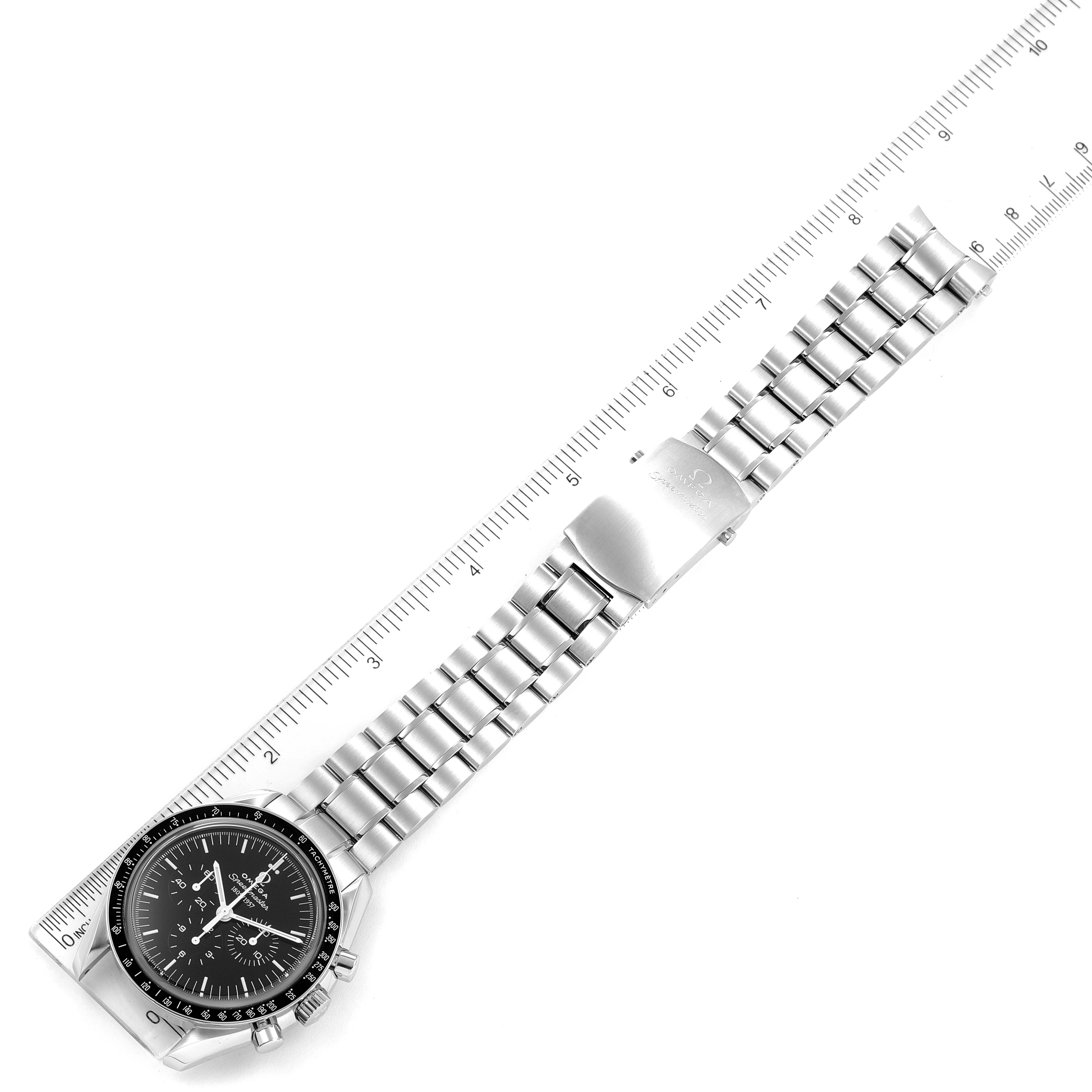 The image shows an Omega Speedmaster 311.33.42.50.01.001 Men's Stainless Steel Black Dial 311.33.42.50.01.001 Men's Stainless Steel Black Dial watch placed horizontally with its bracelet alongside a ruler for scale.