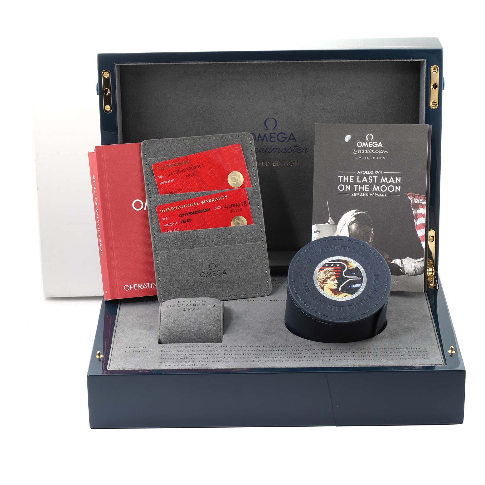 The image shows the packaging and accessories of an Omega Speedmaster 311.30.42.30.03.001 Men's Stainless Steel Blue Dial 311.30.42.30.03.001 Men's Stainless Steel Blue Dial watch, including warranty cards, a booklet, and a watch case.