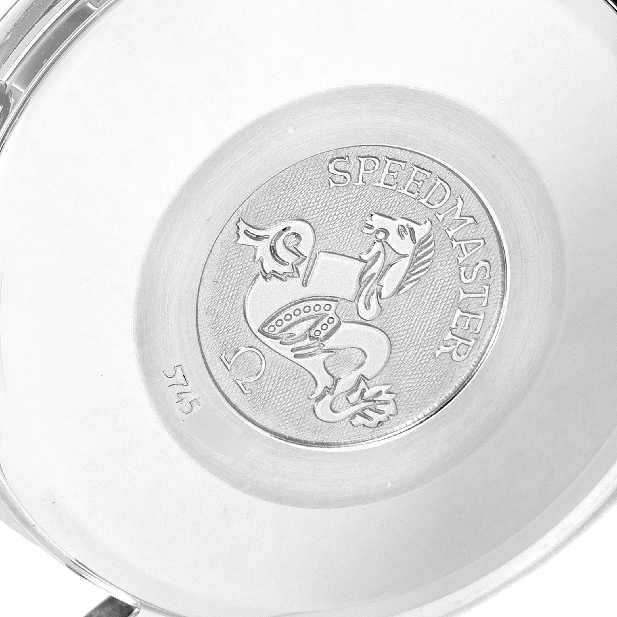 The image shows the back case of an Omega Speedmaster 3523.80.00 Men
s Stainless Steel Blue Dial 3523.80.00 Men
s Stainless Steel Blue Dial watch featuring its emblem and inscriptions.