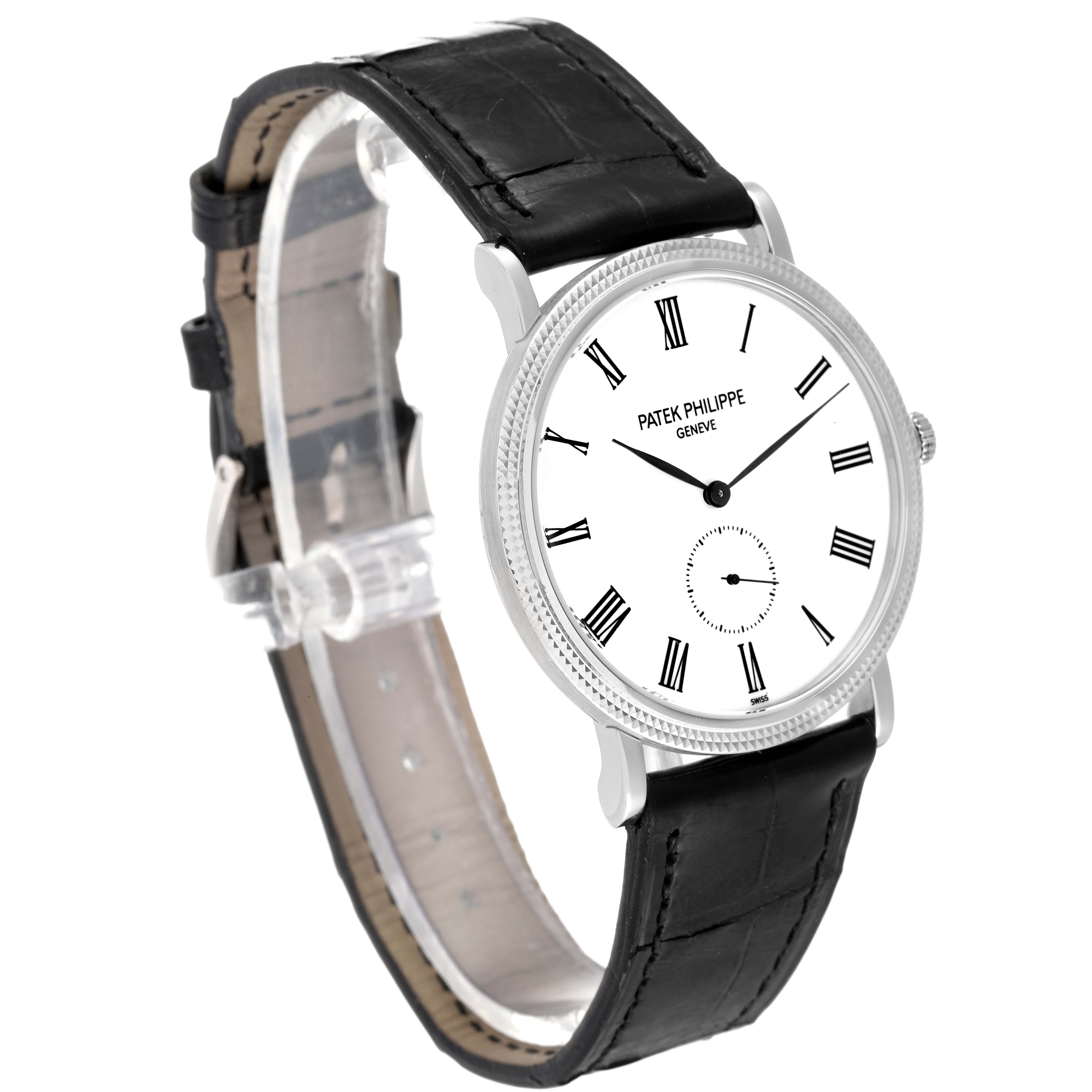 The image shows a side angle of a Patek Philippe Calatrava 5119G Men's White Gold White Dial 5119G Men's White Gold White Dial watch, highlighting its white dial, Roman numerals, and black leather strap.
