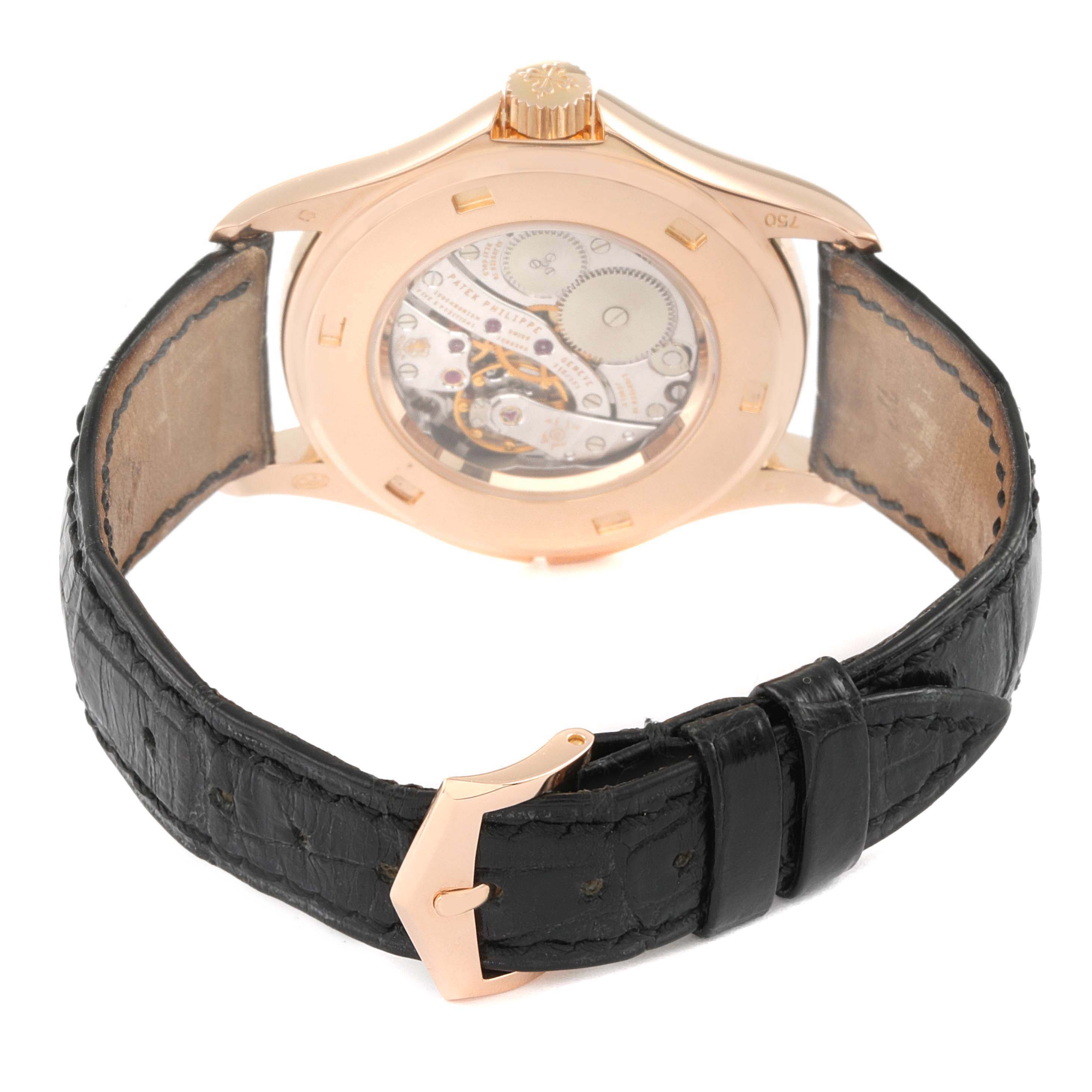 The image shows the back view of a Patek Philippe Calatrava 5134R-011 Men
s Rose Gold Silver Dial 5134R-011 Men
s Rose Gold Silver Dial watch with a visible mechanical movement and a leather strap.