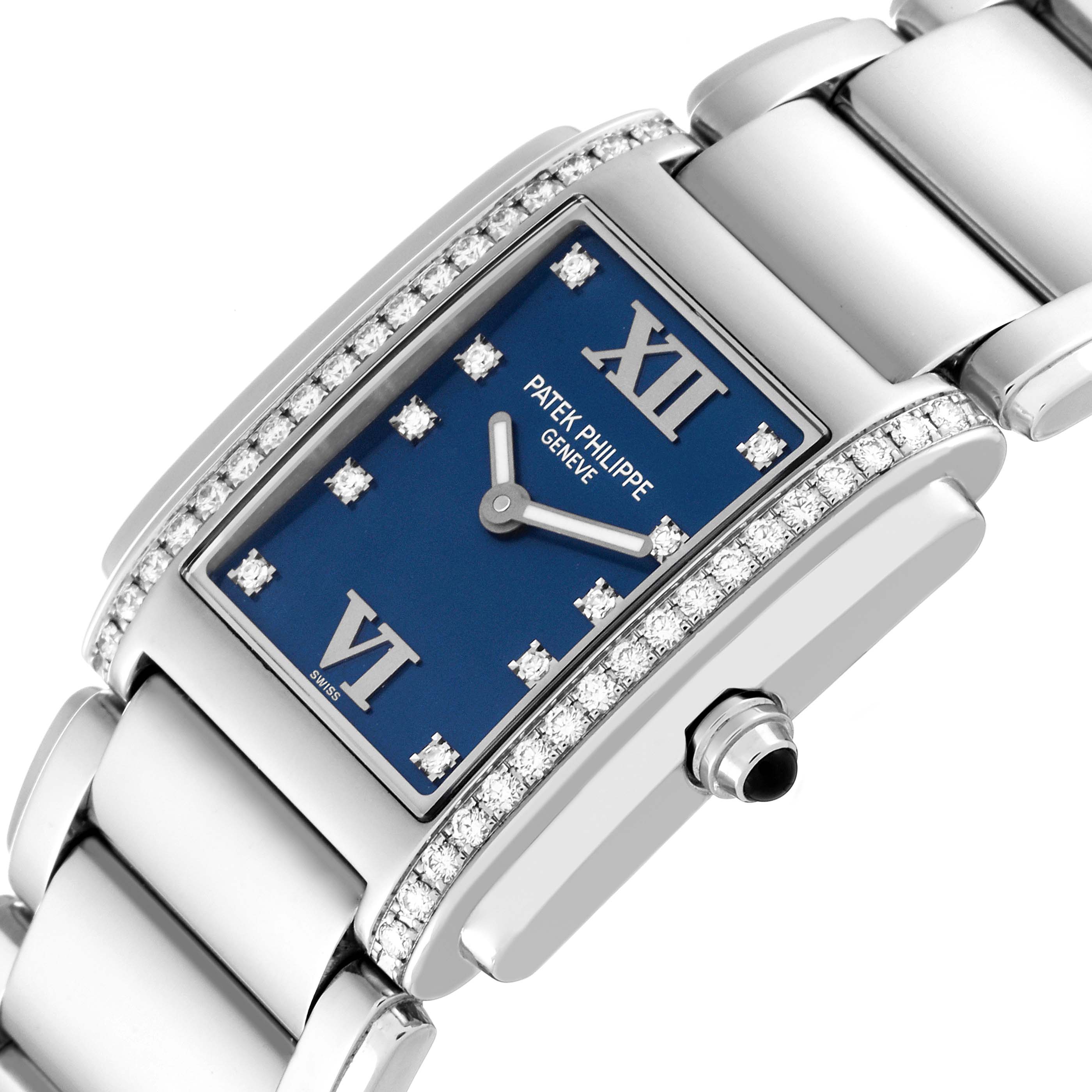 The image shows a close-up of a Patek Philippe Twenty-4 4910/10A-012 Women's Stainless Steel Blue Dial 4910/10A-012 Women's Stainless Steel Blue Dial watch, highlighting its rectangular face and diamond-studded bezel.