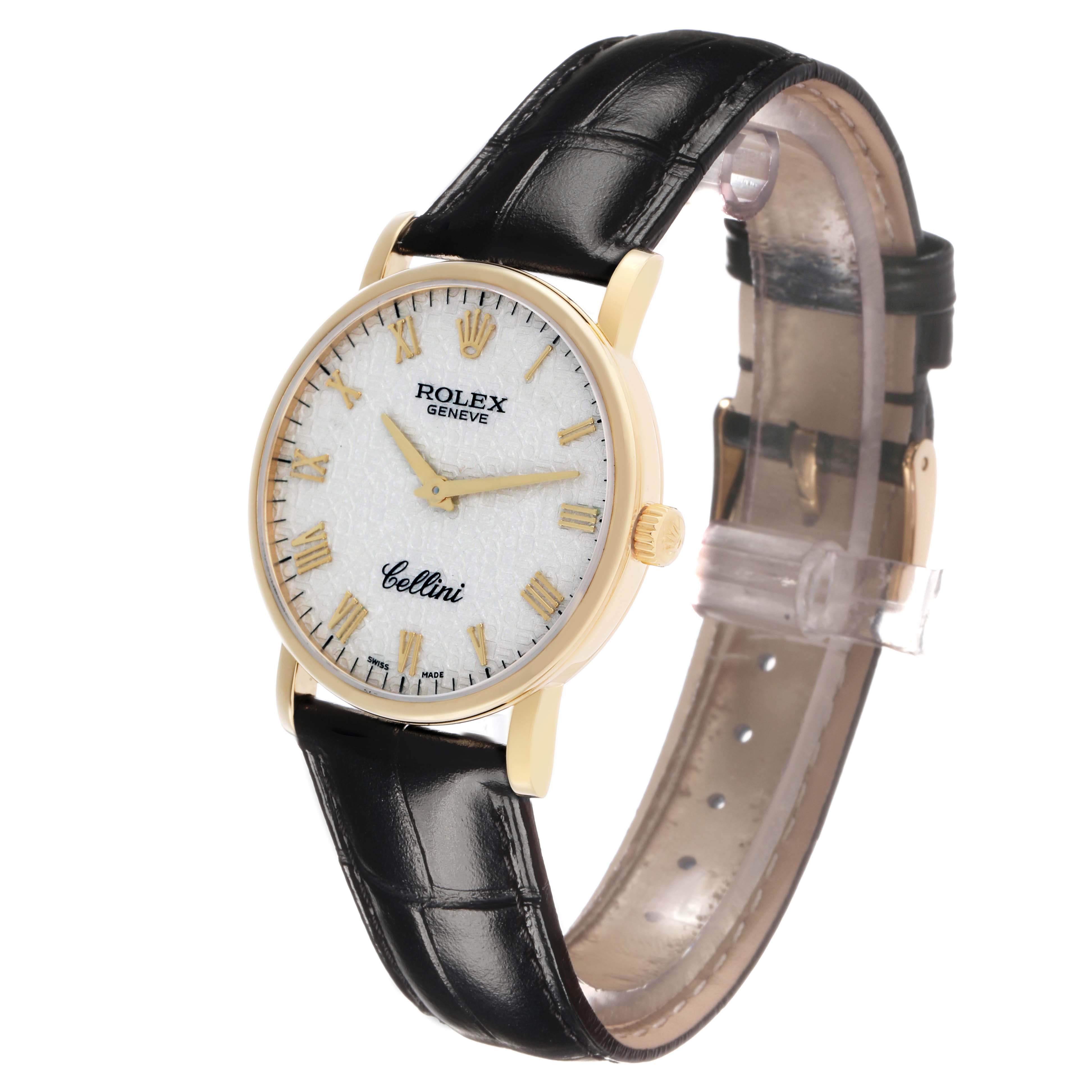 The Rolex Cellini 5115 Men's Yellow Gold Beige Dial watch is displayed at a three-quarter angle, showcasing its gold case, white textured dial, and black leather strap.