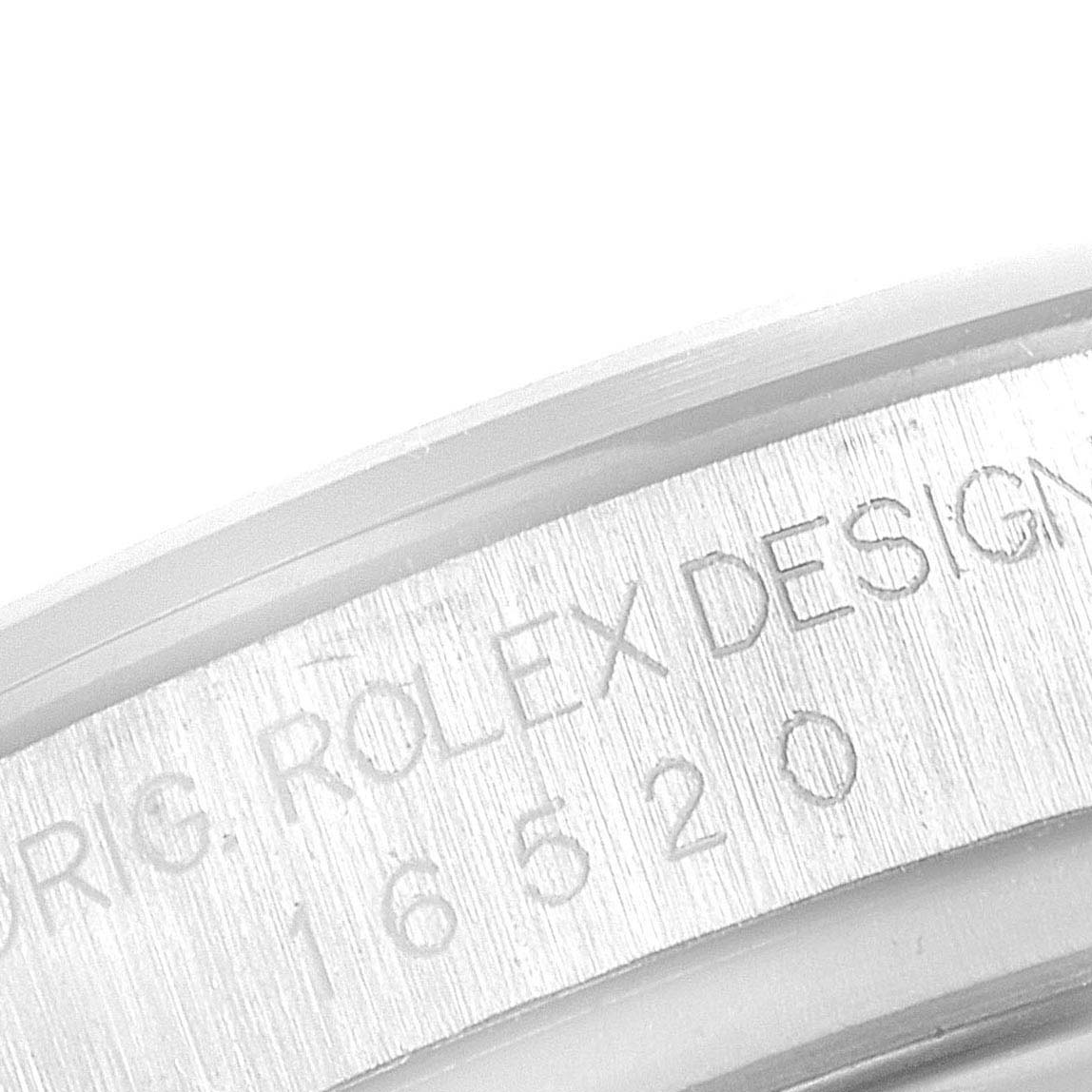 This close-up image shows the engraved text on the side of a Rolex Daytona 16520 Men's Stainless Steel Black Dial 16520 Men's Stainless Steel Black Dial watch case.