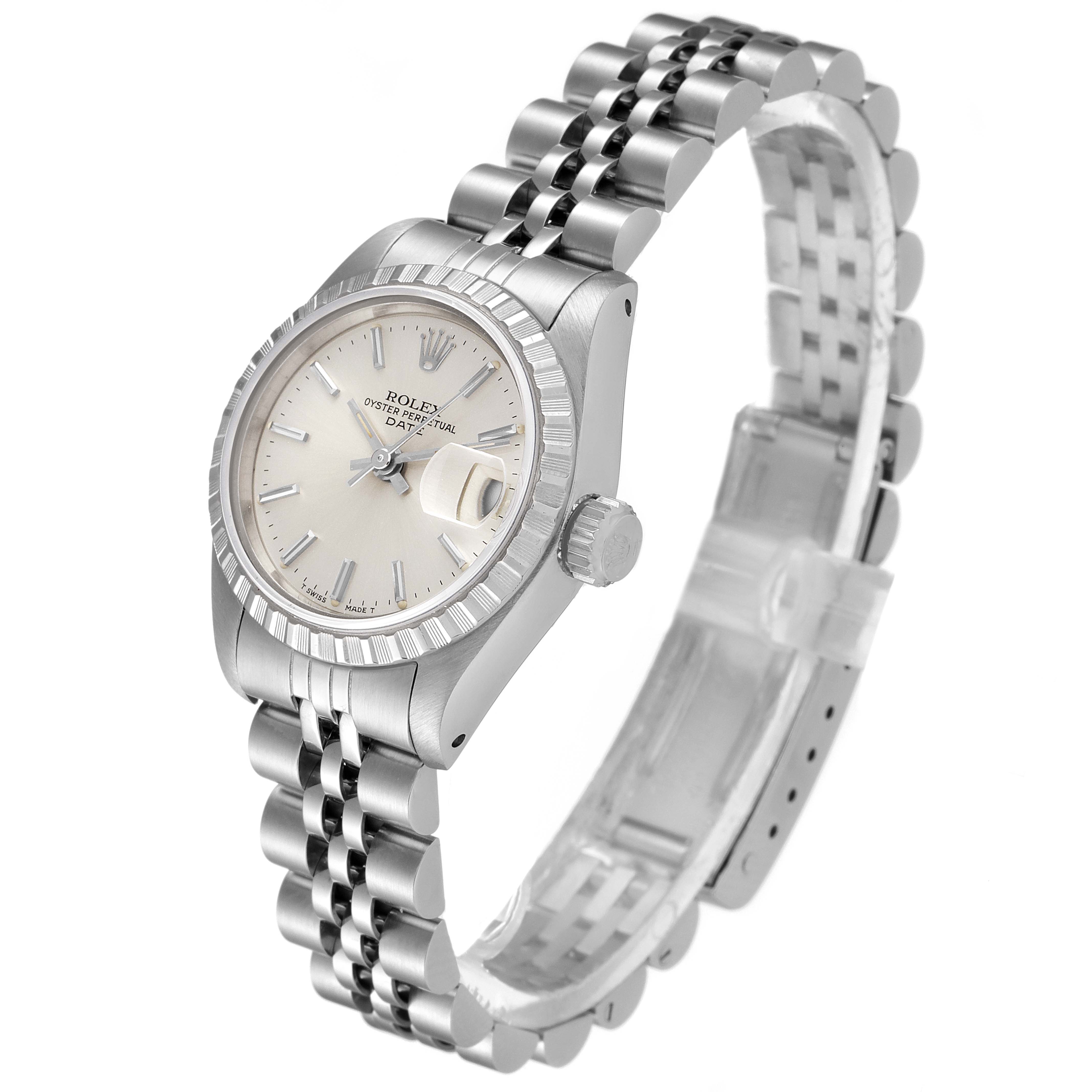 The date model Rolex watch is shown at a slight angle from the front-left, displaying the face, case, bracelet, and crown.