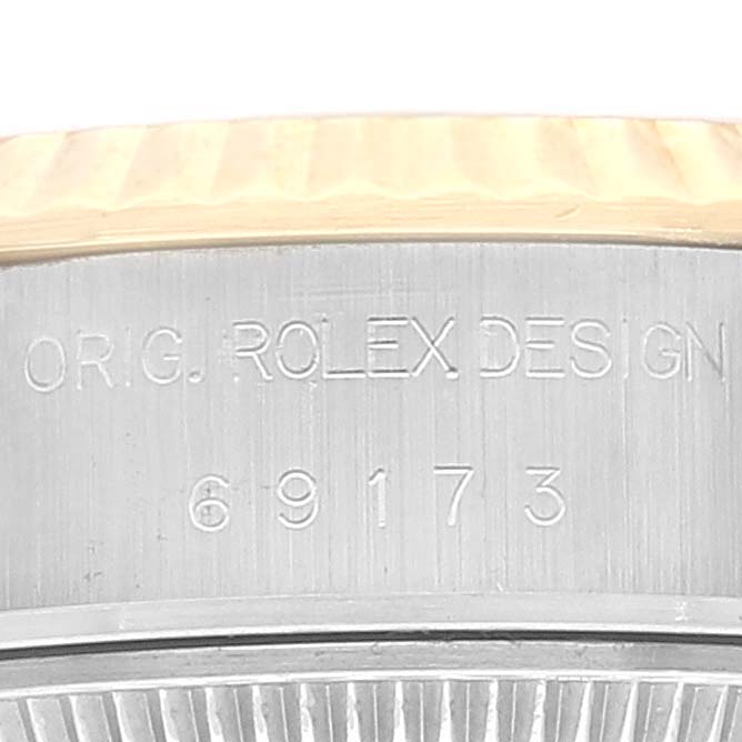 The image shows the side engraving of a Rolex Datejust 69173 Women's Steel and Gold (two tone) Champagne Dial 69173 Women's Steel and Gold (two tone) Champagne Dial model, focusing on the model number '69173' and 'ORIG. ROLEX DESIGN'.