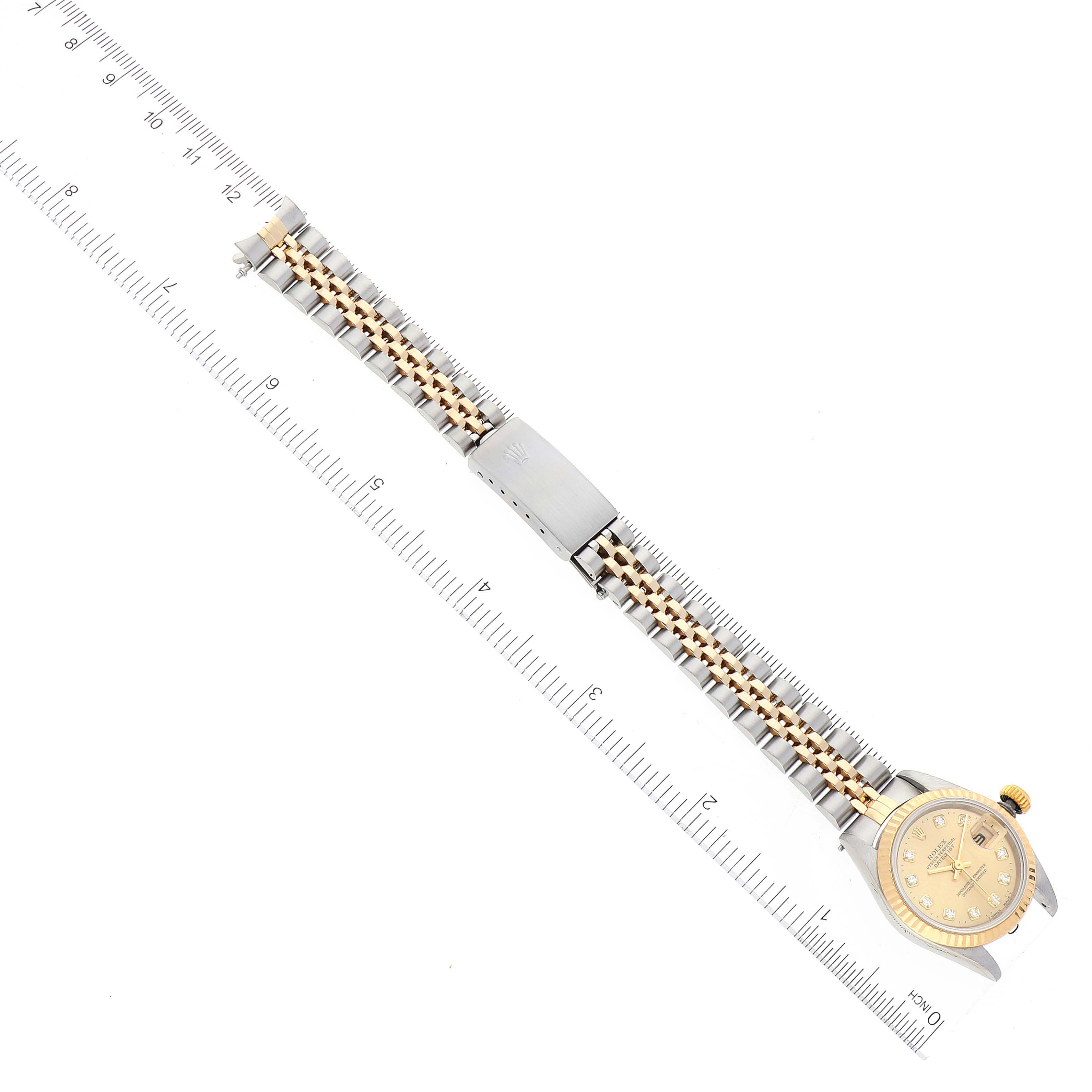 The image shows a Rolex Datejust 69173 Women's Steel and Gold (two tone) Champagne Dial 69173 Women's Steel and Gold (two tone) Champagne Dial watch lying flat, featuring its face, clasp, and full bracelet, measured against a ruler.
