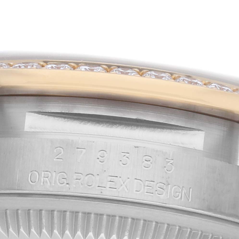 The image shows a close-up of the Rolex Datejust 279383 Women's Steel and Gold (two tone) Mother of Pearl Dial watch's case side with engraved numbers and the edge of a jeweled bezel.