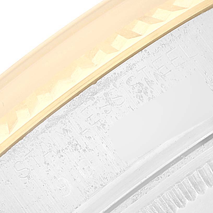 The image shows a close-up angle of the Rolex Datejust 16013 Men's Steel and Gold (two tone) Champagne Dial 16013 Men's Steel and Gold (two tone) Champagne Dial model watch's fluted bezel and part of the case.