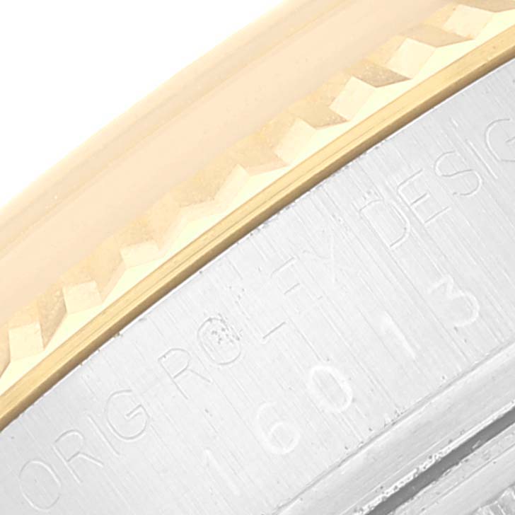 This close-up image shows the detailed engraving on the side of the bezel and case of a Rolex Datejust 16013 Men's Steel and Gold (two tone) Champagne Dial 16013 Men's Steel and Gold (two tone) Champagne Dial watch.