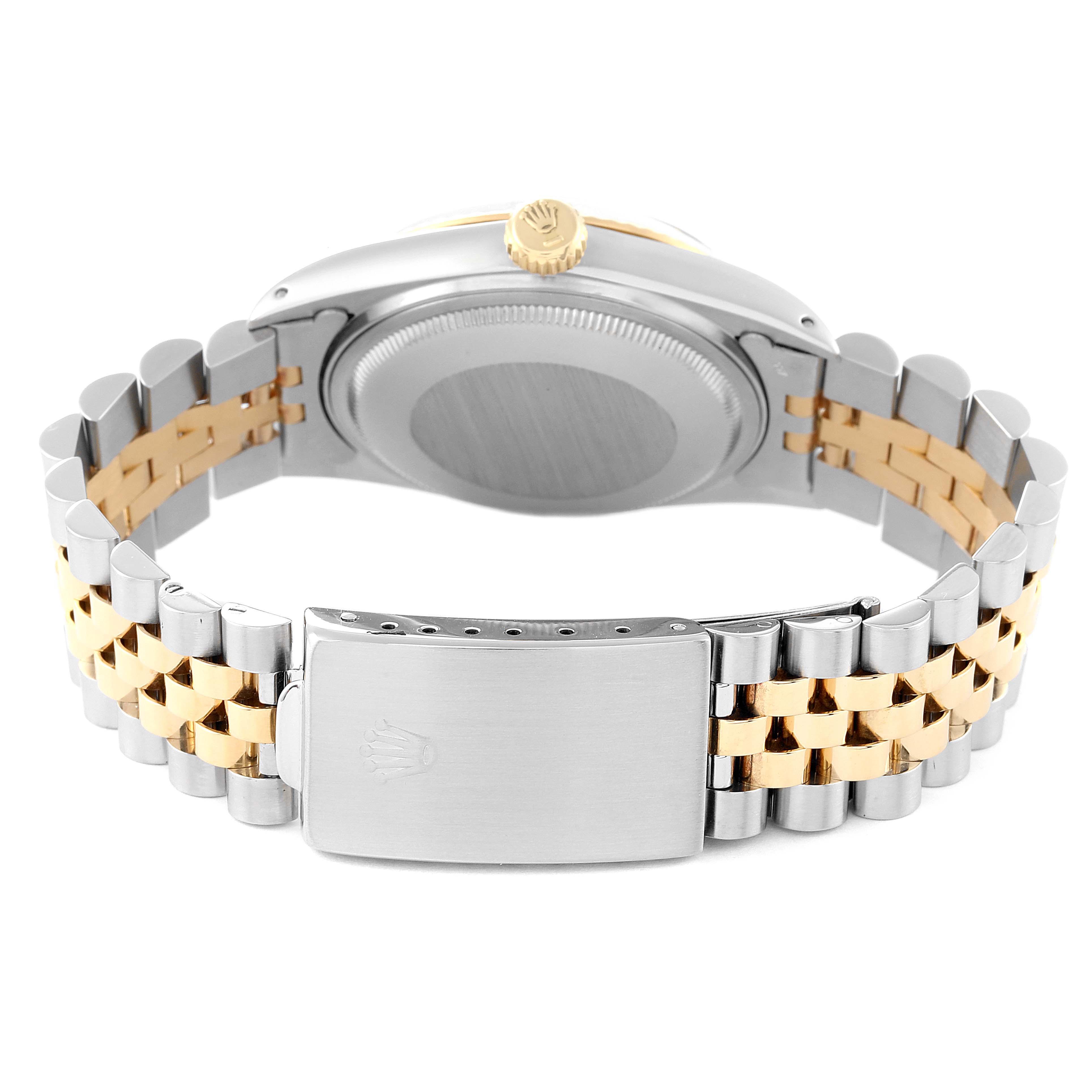 The image shows the back of a Rolex Vintage Collection 16013 Men
s Steel and Gold (two tone) Champagne Dial 16013 Men
s Steel and Gold (two tone) Champagne Dial watch, focusing on the case back, crown, and two-tone bracelet.