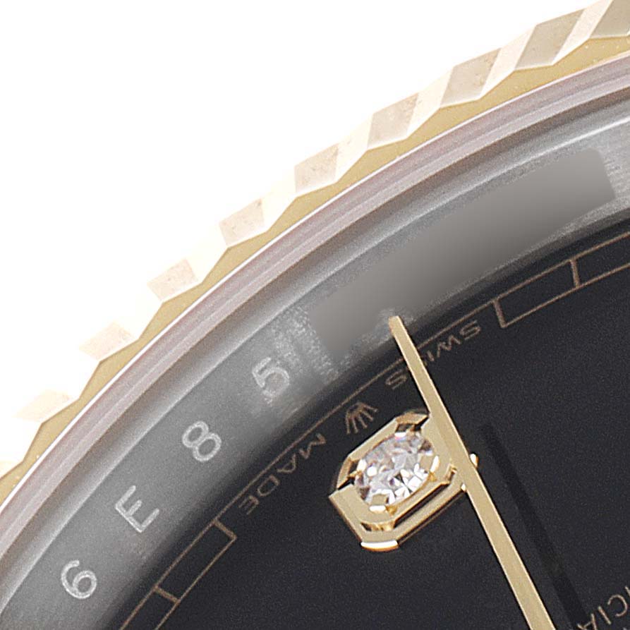 This close-up image of the Rolex Datejust 41 126333 Men's Steel and Gold (two tone) Black Dial 126333 Men's Steel and Gold (two tone) Black Dial shows the bezel, part of the dial, and hour markers.