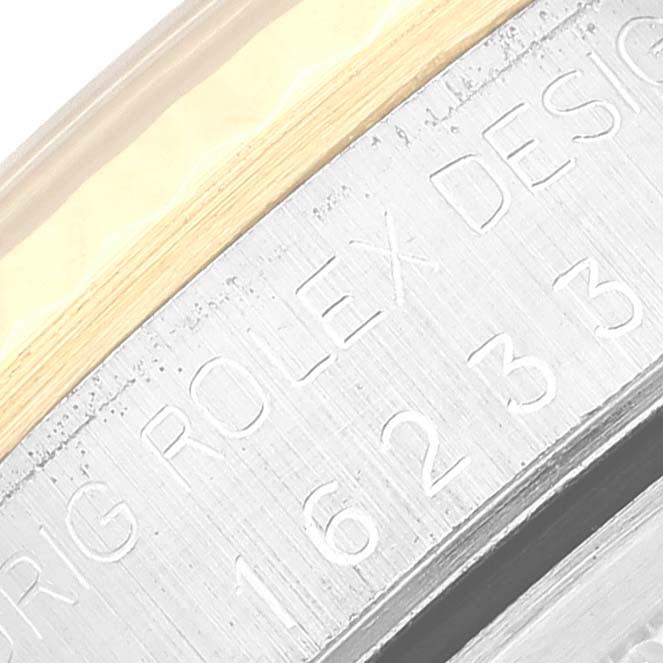 The image shows a close-up angled view of the side engraving on a Rolex Datejust 16233 Men's Steel and Gold (two tone) Champagne Dial 16233 Men's Steel and Gold (two tone) Champagne Dial watch.