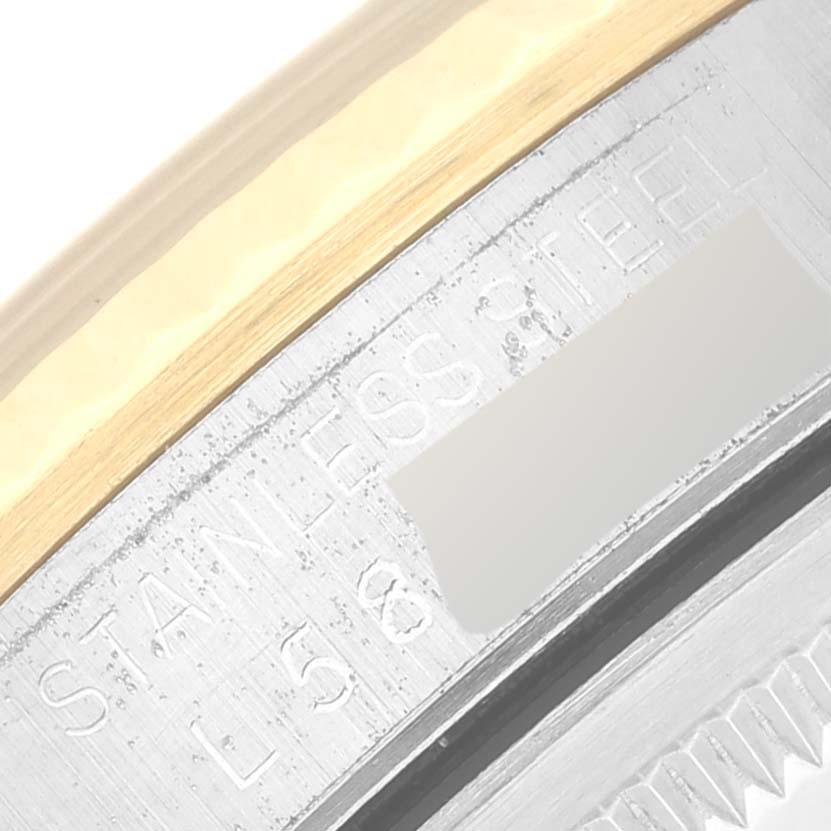 This image shows a close-up of the side engraving on the stainless steel casing of a Rolex Datejust 16233 Men's Steel and Gold (two tone) Champagne Dial 16233 Men's Steel and Gold (two tone) Champagne Dial watch.