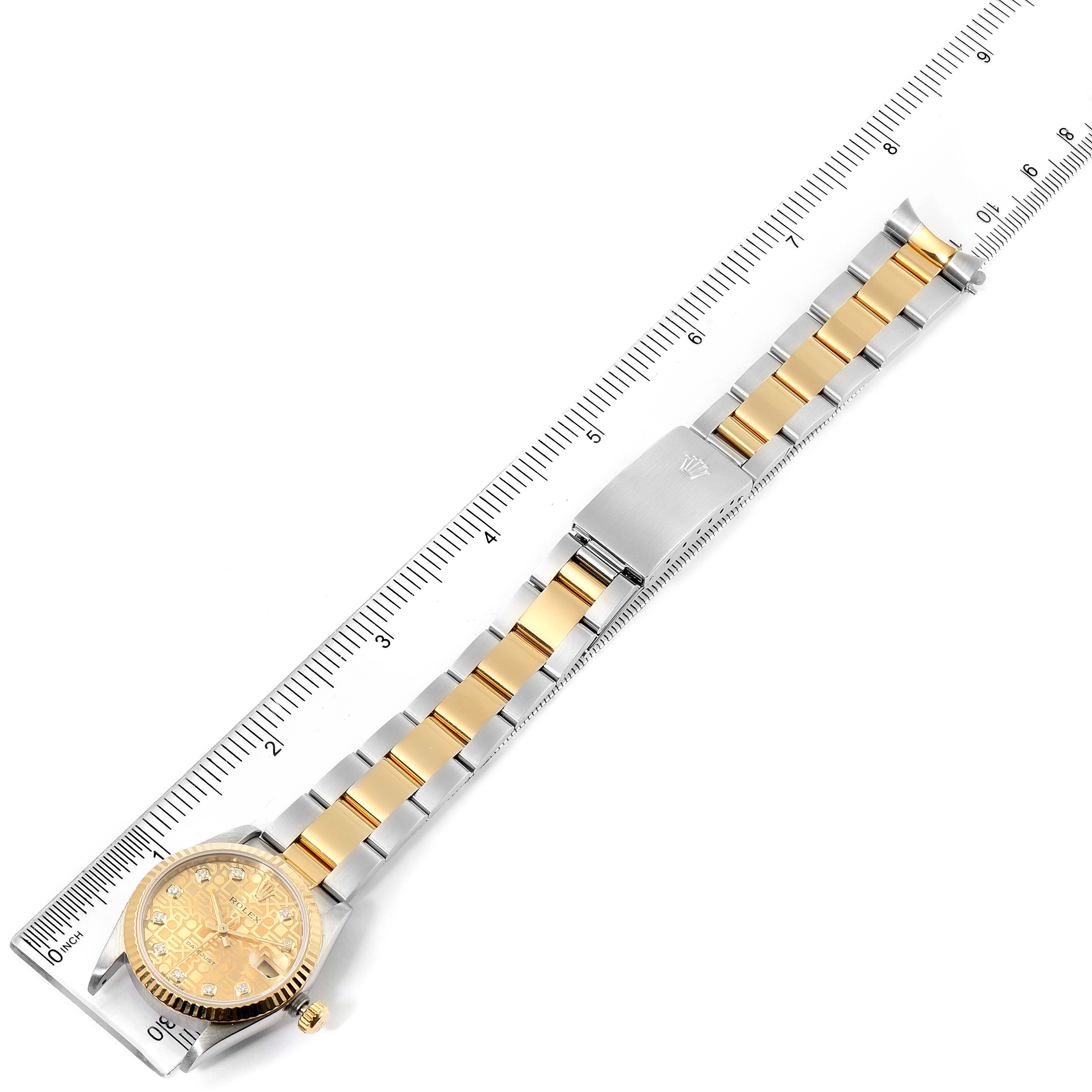 The image shows a top view of the Rolex Mid-Size 68273 Women's Steel and Gold (two tone) Champagne Dial 68273 Women's Steel and Gold (two tone) Champagne Dial watch, featuring its full bracelet and face alongside a measuring ruler.