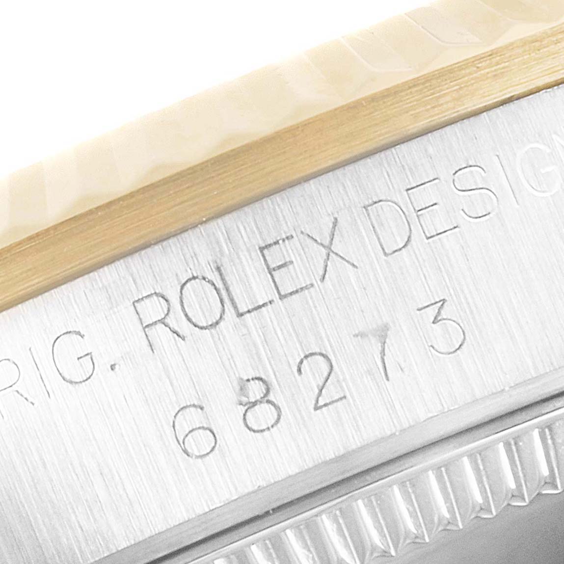 This image shows a close-up of the side engraving and edge details of a Rolex Mid-Size 68273 Women's Steel and Gold (two tone) Champagne Dial 68273 Women's Steel and Gold (two tone) Champagne Dial watch.