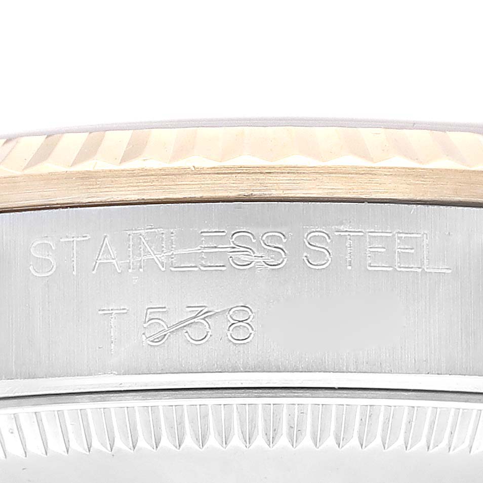 This image shows the side view of the bezel and case of a Rolex Mid-Size 68273 Women's Steel and Gold (two tone) Champagne Dial 68273 Women's Steel and Gold (two tone) Champagne Dial model, with the text "STAINLESS STEEL" engraved on the case.