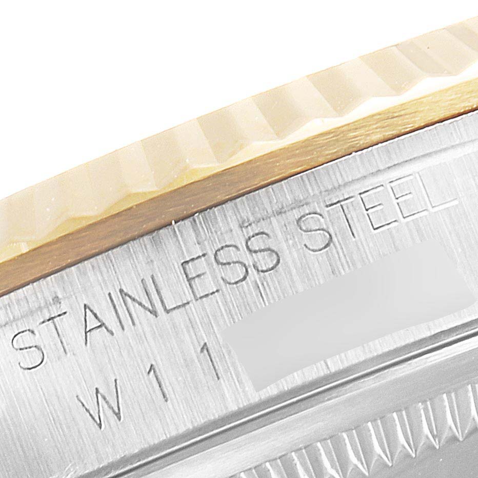 This close-up image of the Rolex Datejust 16233 Men's Steel and Gold (two tone) Champagne Dial 16233 Men's Steel and Gold (two tone) Champagne Dial watch shows the edge of the 18K fluted bezel and the stainless steel side casing.