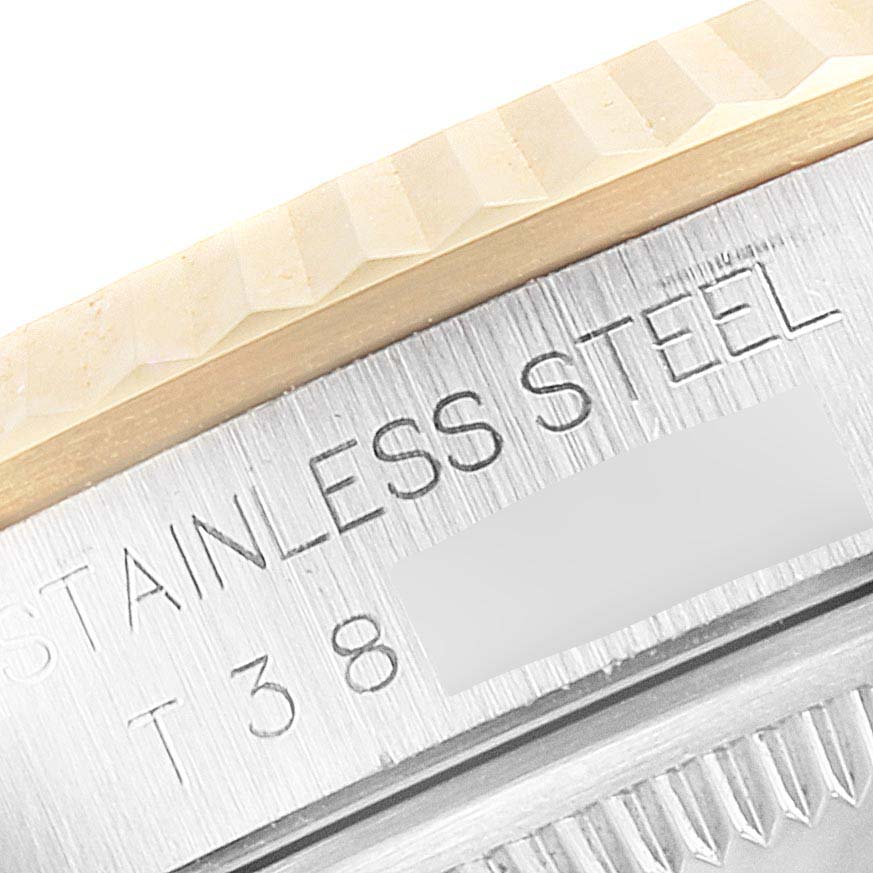 This close-up image shows the stainless steel case back and fluted bezel of a Rolex Datejust 16233 Men's Steel and Gold (two tone) Champagne Dial 16233 Men's Steel and Gold (two tone) Champagne Dial watch.