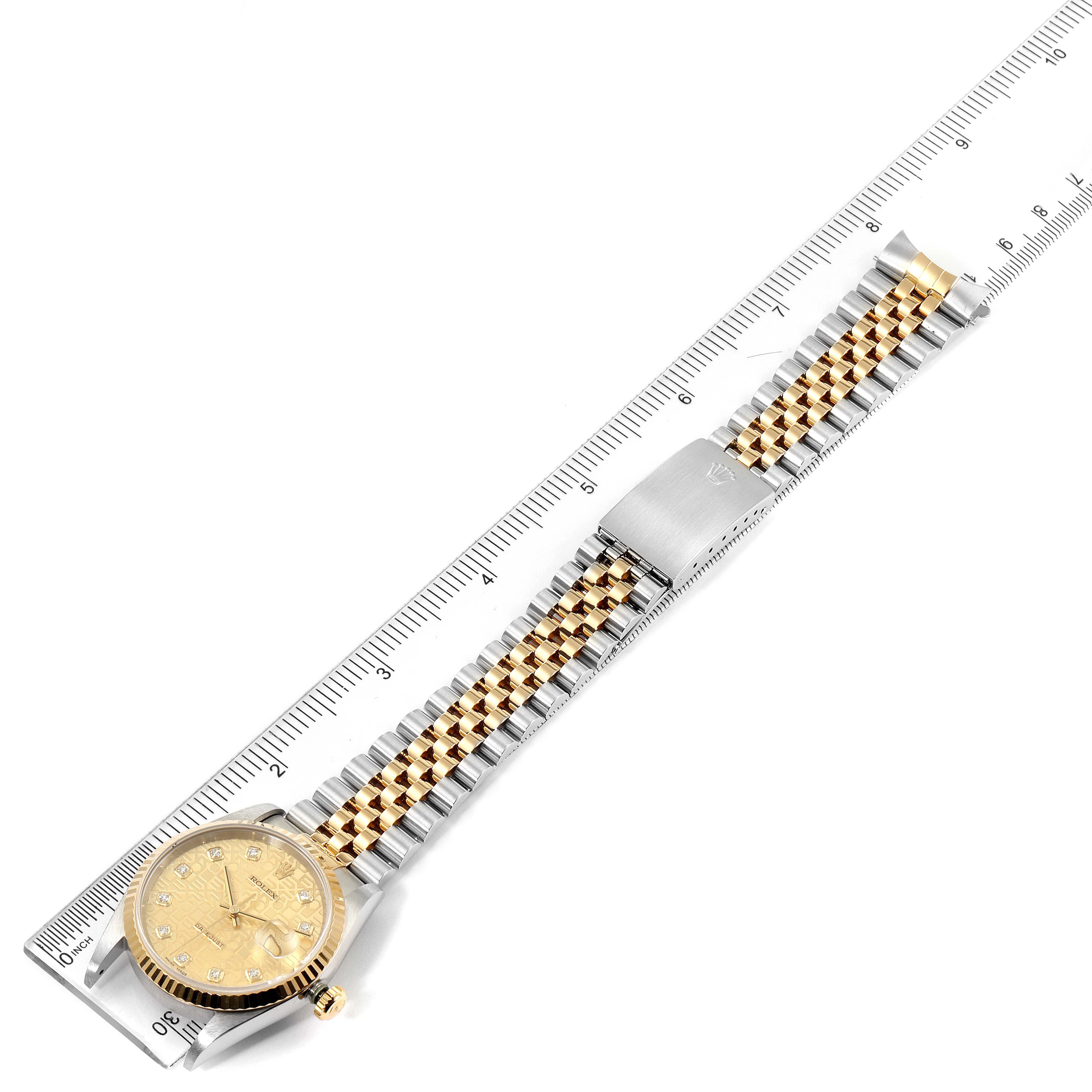 The image shows the Rolex Datejust 16233 Men's Steel and Gold (two tone) Champagne Dial 16233 Men's Steel and Gold (two tone) Champagne Dial watch from an overhead angle, displaying the face, bracelet, and clasp, with a ruler for scale.