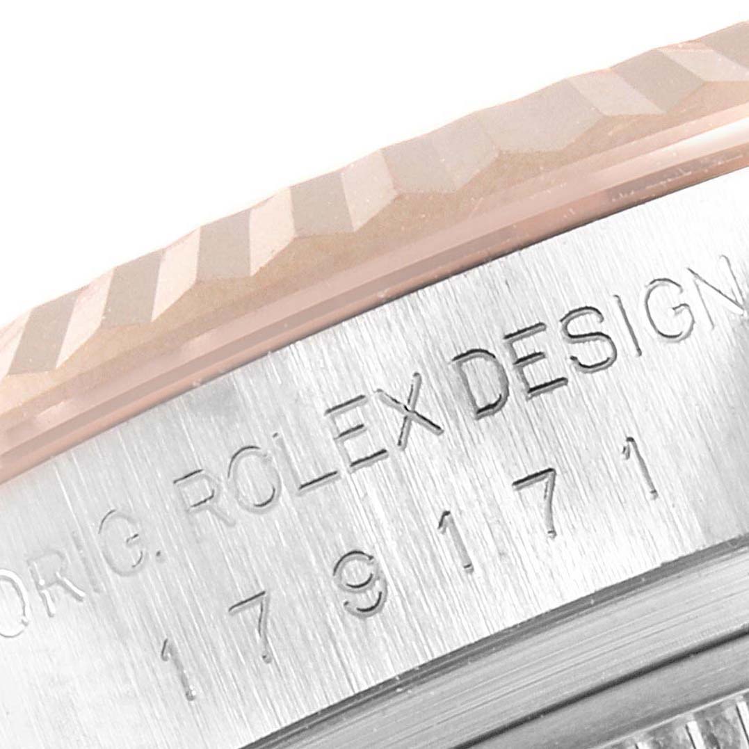 The image shows a close-up of the bezel and case side of the Rolex Datejust 179171 Women's Rose Gold Pink Dial 179171 Women's Rose Gold Pink Dial watch, highlighting the engraved text and fluted bezel.