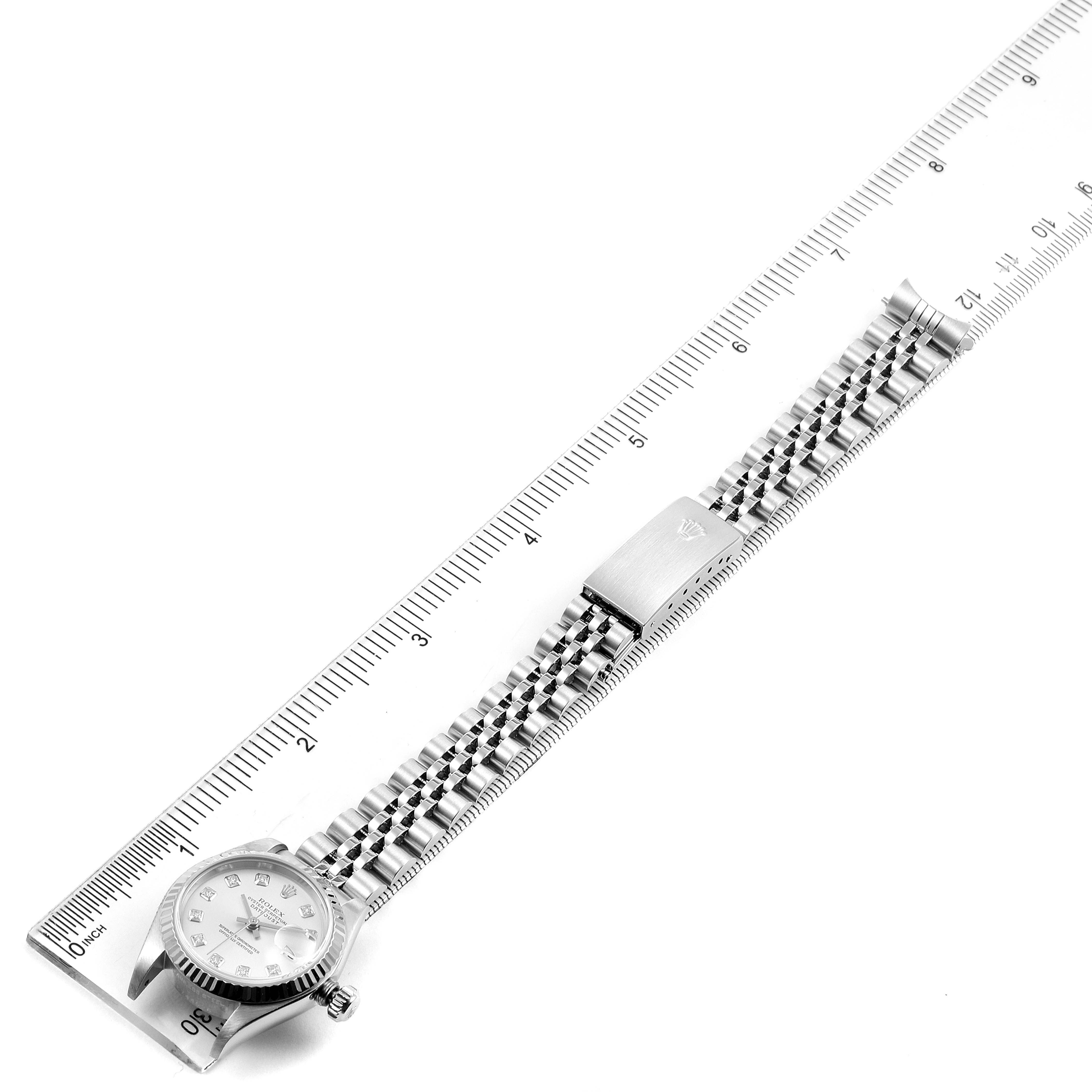 The image shows a Rolex Datejust 79174 Women's Stainless Steel Silver Dial 79174 Women's Stainless Steel Silver Dial watch laid flat on a ruler, displaying its dial, bracelet, and clasp.