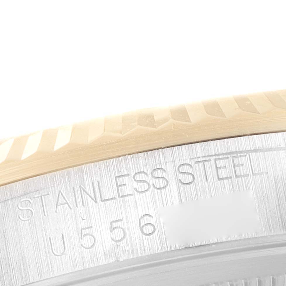 This close-up shot of the Rolex Datejust 16233 Men's Steel and Gold (two tone) Black Dial 16233 Men's Steel and Gold (two tone) Black Dial watch showcases the edge of the fluted bezel and part of the stainless steel casing.