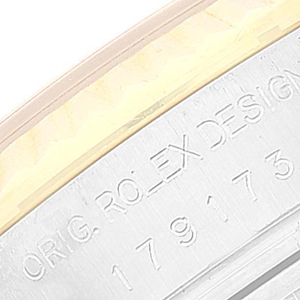 The image shows a close-up of the engraved serial number and "ORIG. ROLEX DESIGN" on the rim of a Rolex Datejust 179173 Women's Steel and Gold (two tone) Champagne Dial 179173 Women's Steel and Gold (two tone) Champagne Dial watch.