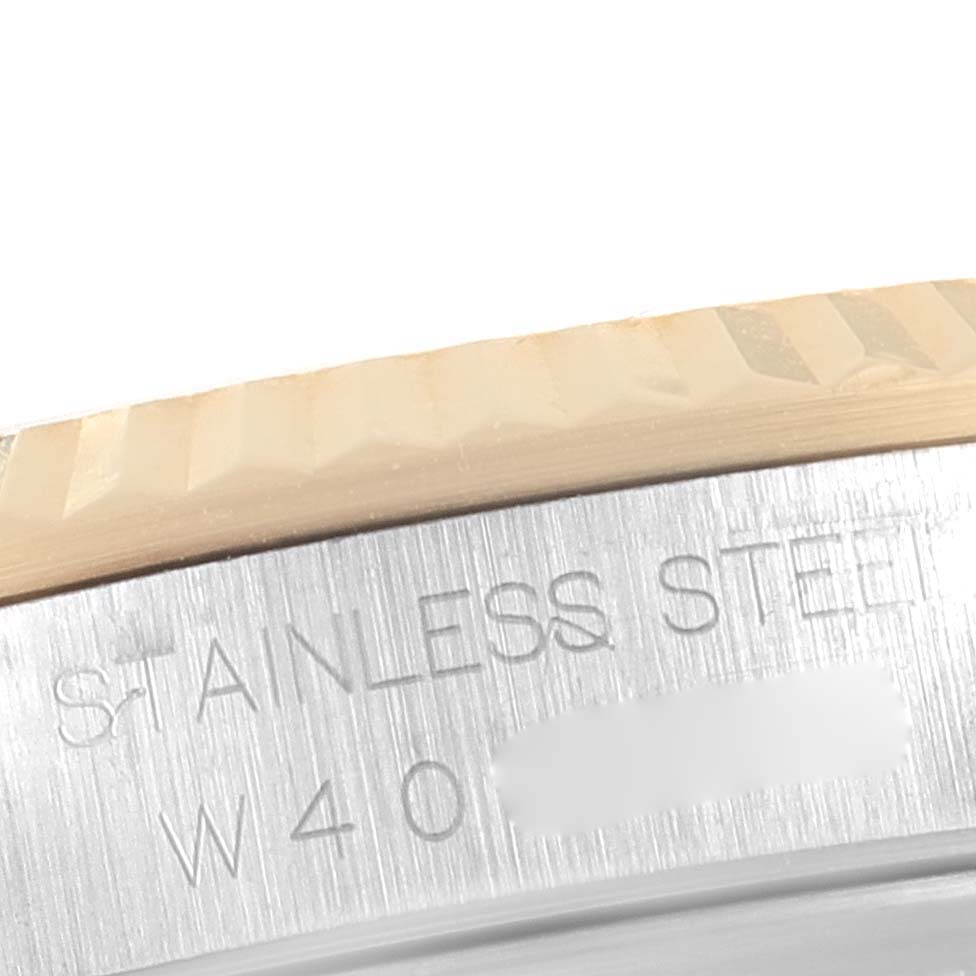 The image shows a close-up angle of the Rolex Datejust 16233 Men's Steel and Gold (two tone) Champagne Dial 16233 Men's Steel and Gold (two tone) Champagne Dial watch, highlighting the fluted bezel and part of the stainless steel casing.