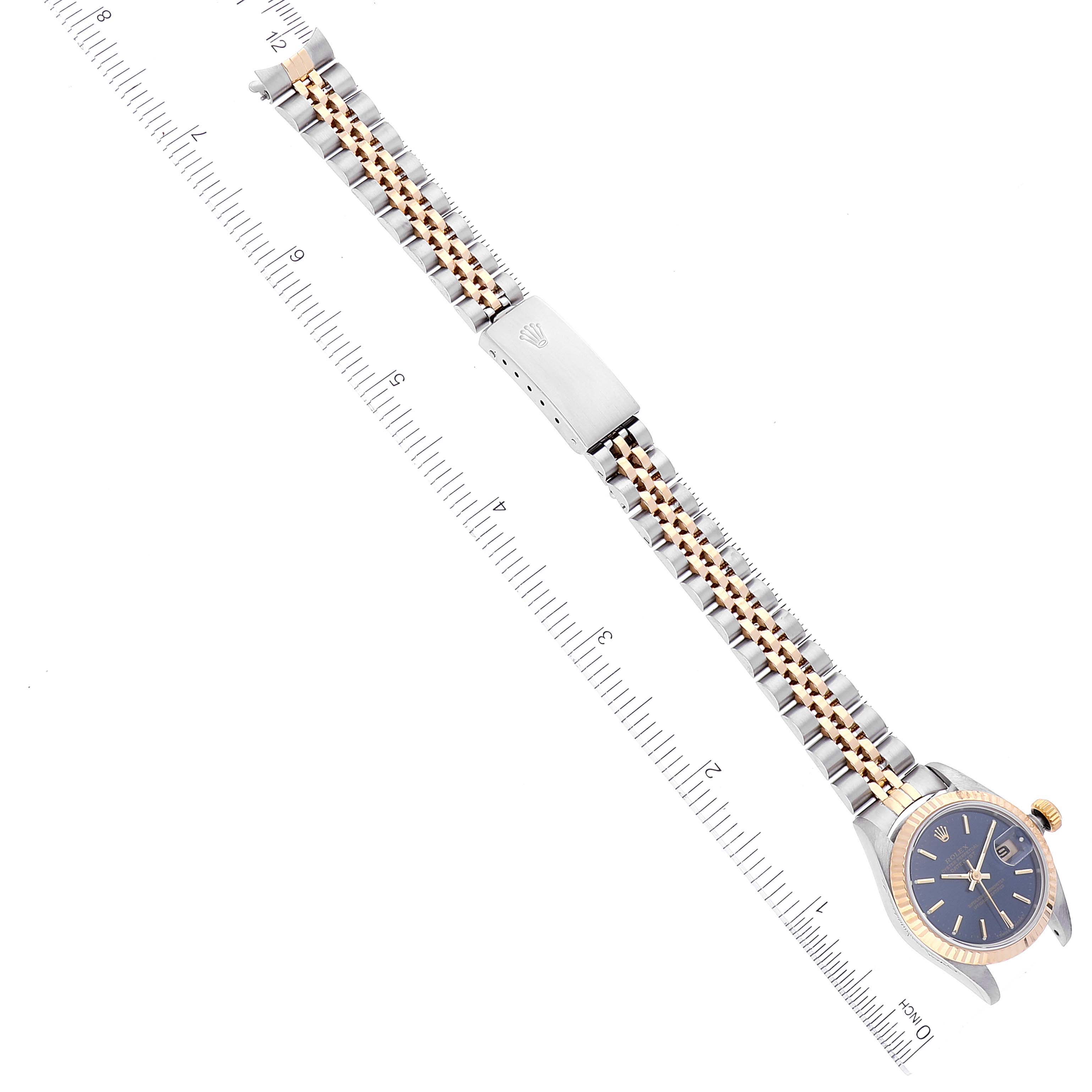 The image shows a Rolex Datejust 69173 Women's Steel and Gold (two tone) Blue Dial 69173 Women's Steel and Gold (two tone) Blue Dial watch from a top view, highlighting its bracelet, clasp, and partially the face, along with a measuring ruler.