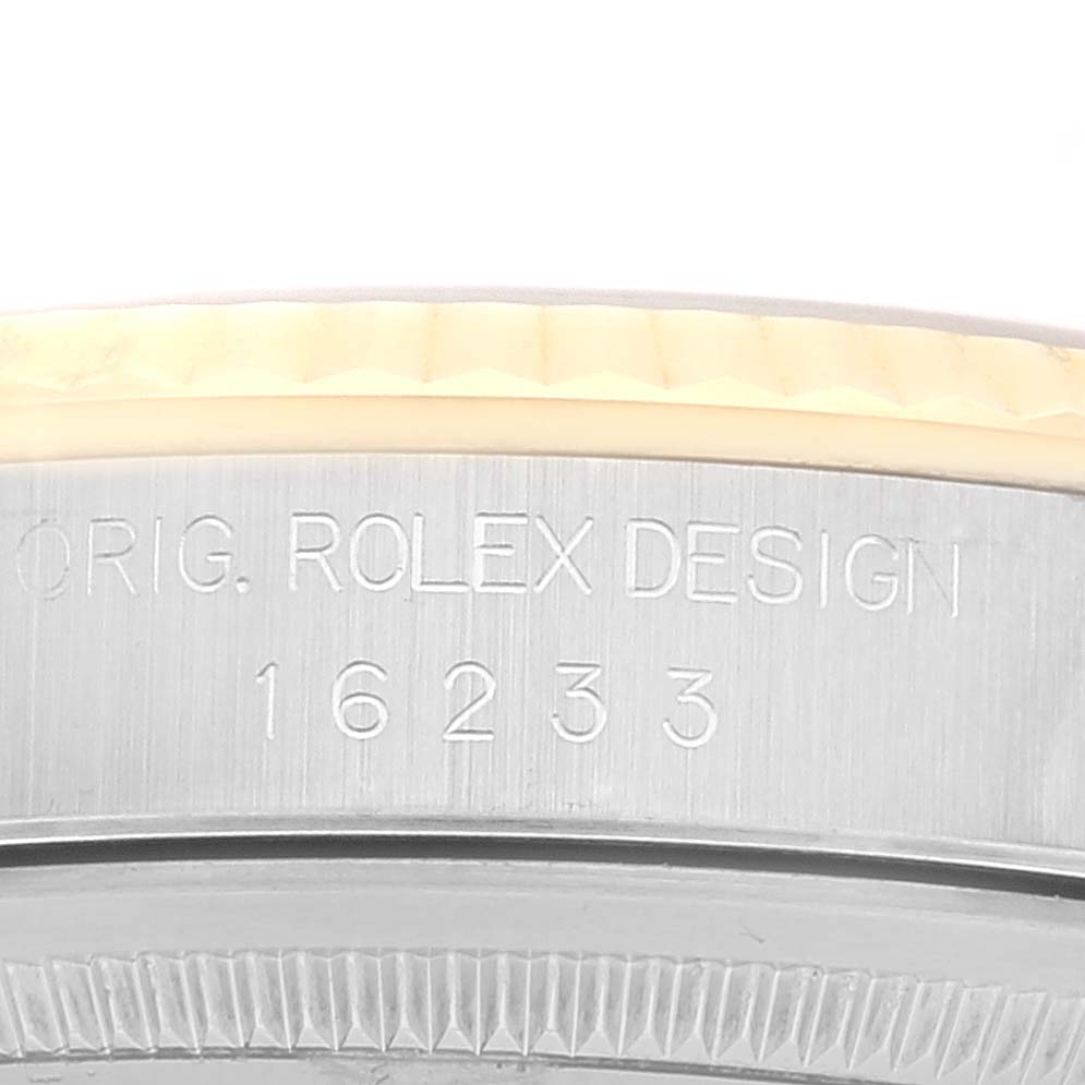 The image shows a close-up of the side of the bezel and case with engraved details of the Rolex Datejust 16233 Men's Steel and Gold (two tone) Mother of Pearl Dial 16233 Men's Steel and Gold (two tone) Mother of Pearl Dial model 16233.