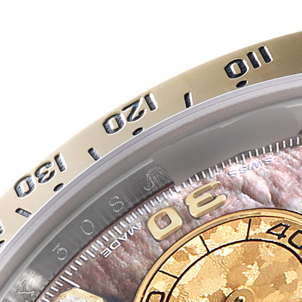This close-up shot of the Rolex Daytona 116523 Men's Steel and Gold (two tone) Mother of Pearl Dial 116523 Men's Steel and Gold (two tone) Mother of Pearl Dial shows the bezel with engraved numerals and part of the dial with detailed markings.