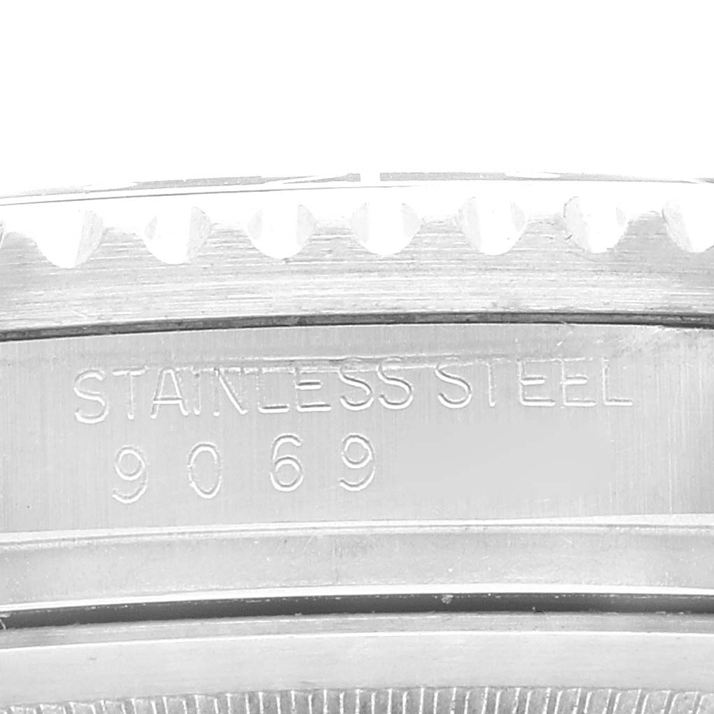 The image shows a close-up of the side of a Rolex GMT-Master 16760 Men
s Stainless Steel Black Dial 16760 Men
s Stainless Steel Black Dial watch case, highlighting its stainless steel material and the number 9069.