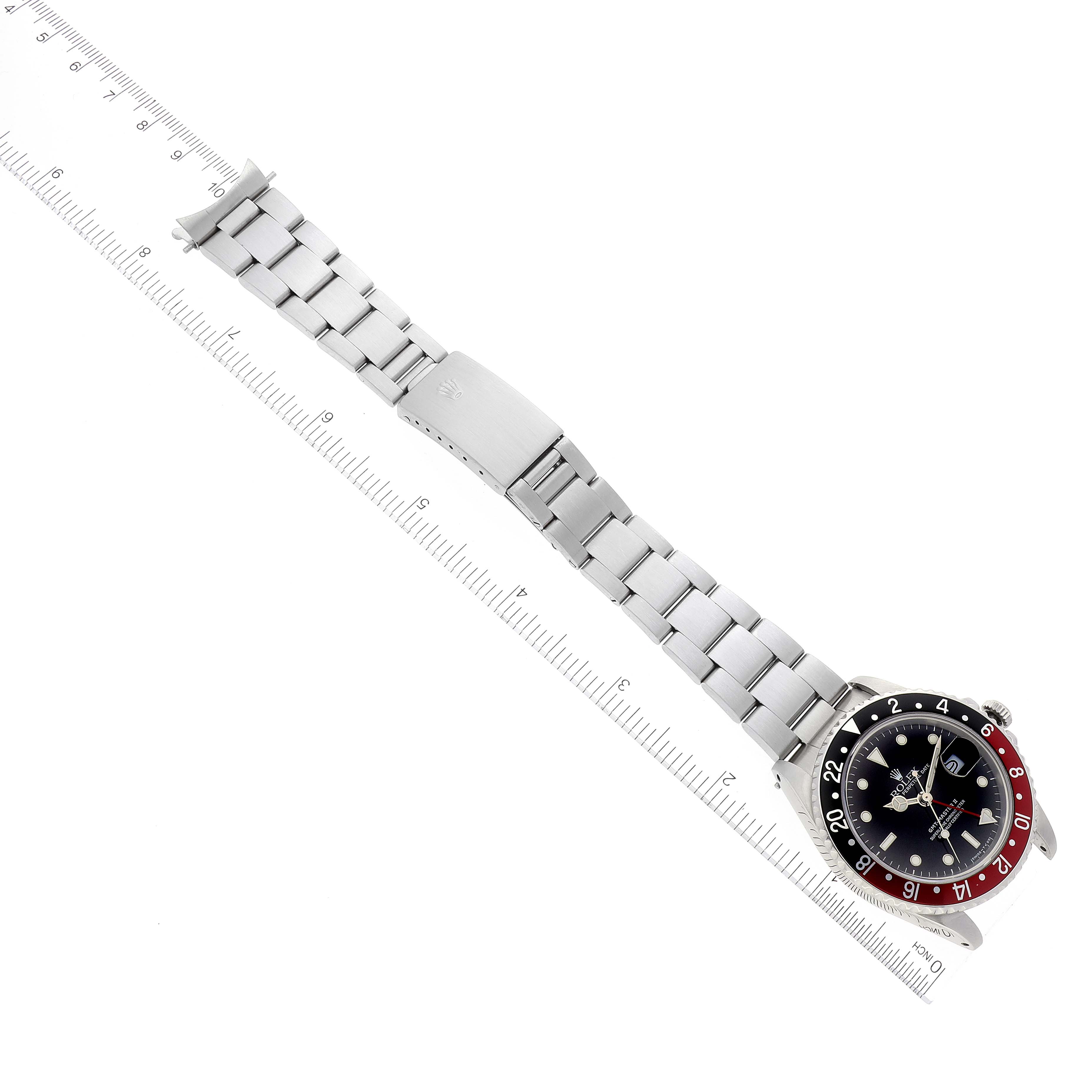 The image displays a Rolex GMT-Master 16760 Men
s Stainless Steel Black Dial 16760 Men
s Stainless Steel Black Dial watch, showcasing the entire watch face, bezel, and bracelet laid flat alongside a ruler.