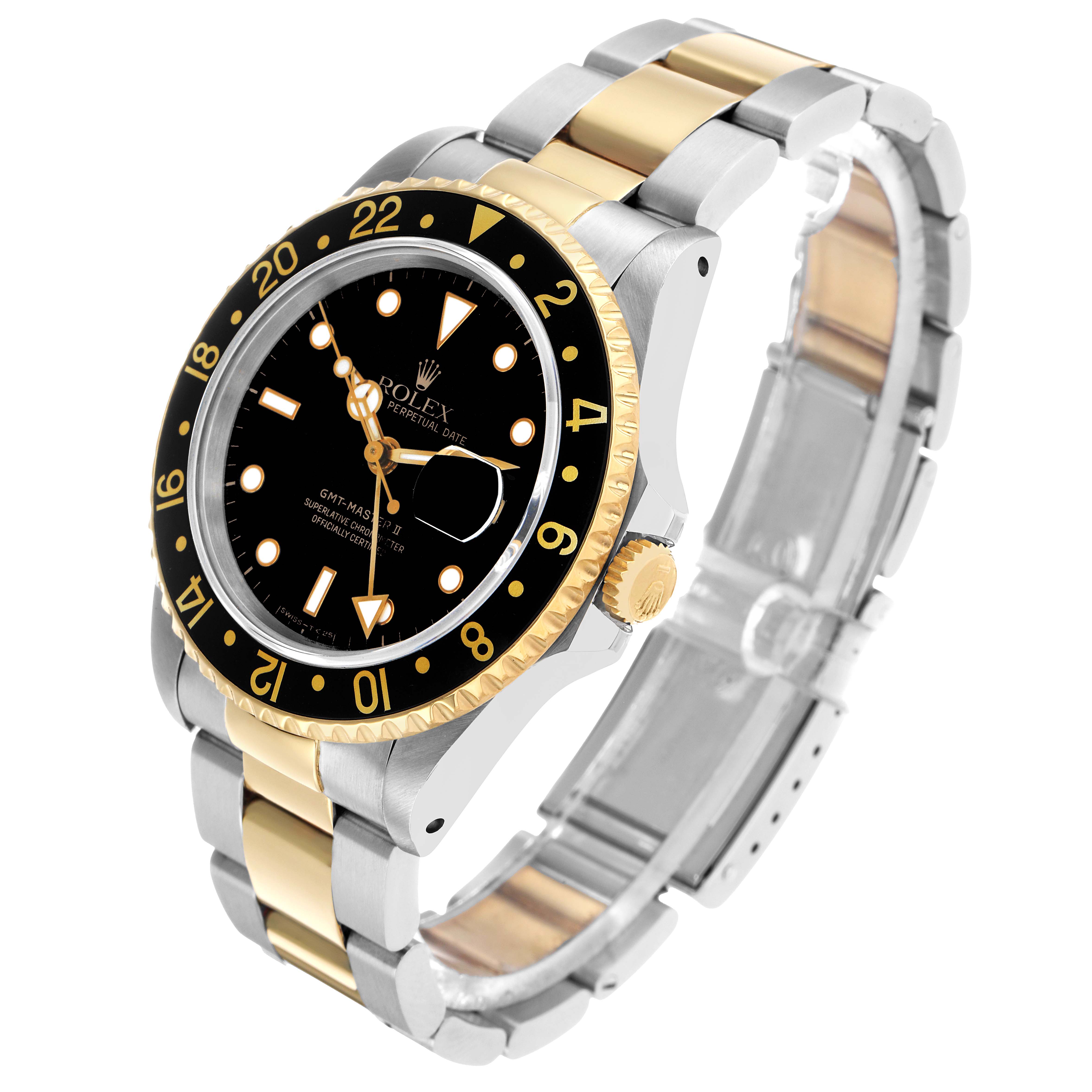 The Rolex GMT-Master 16713 Men's Steel and Gold (two tone) Black Dial watch is shown at a three-quarter angle, highlighting the bezel, crown, and two-tone bracelet.