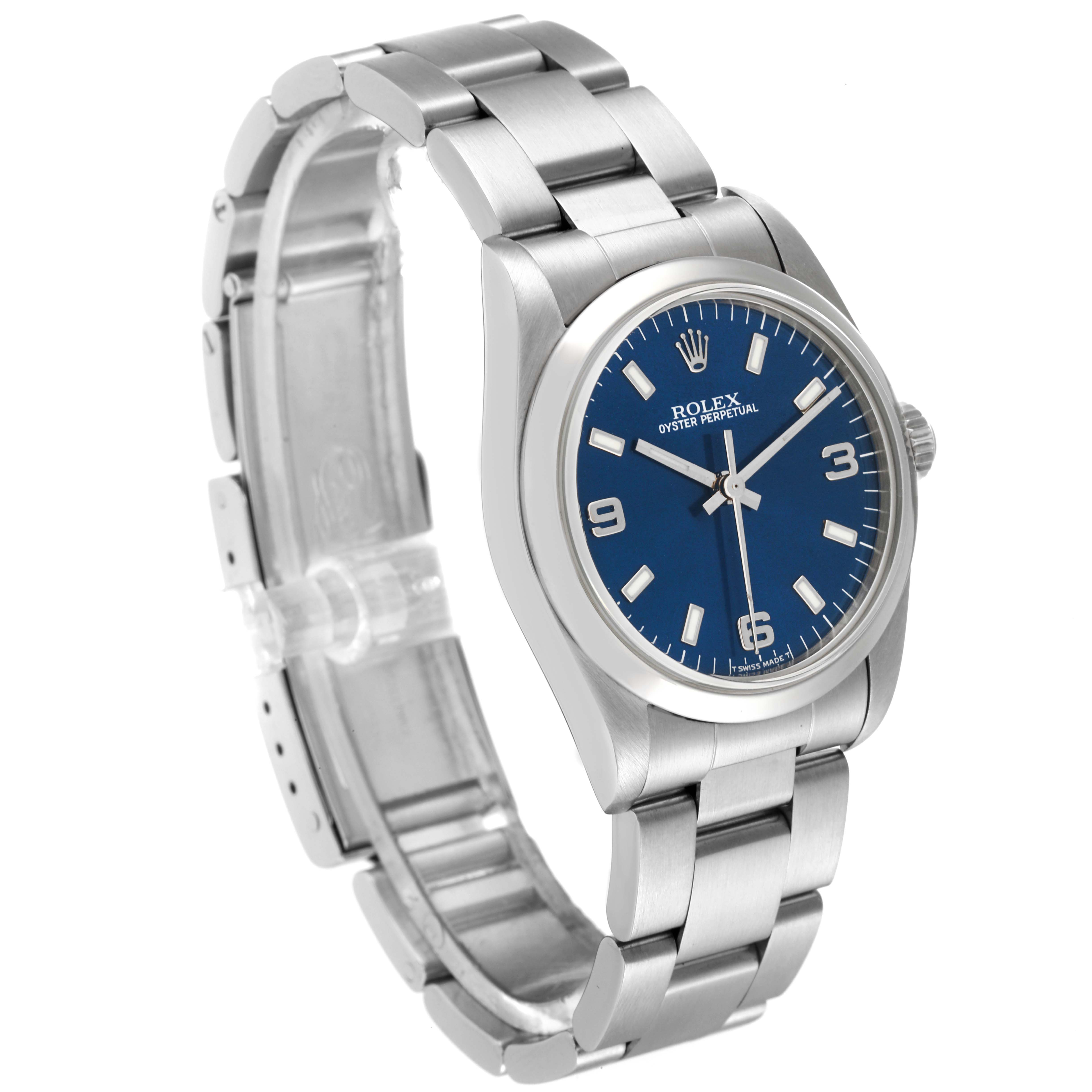 The image shows a Mid-Size Rolex Oyster Perpetual watch with a blue dial and stainless steel bracelet, angled slightly to the left.