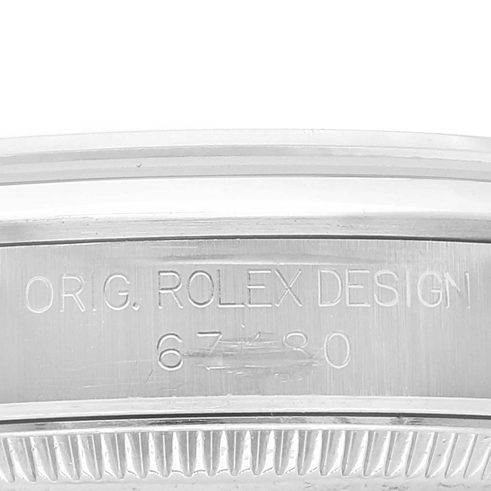 The image shows an engraved view of the casing on a Mid-Size Rolex watch.