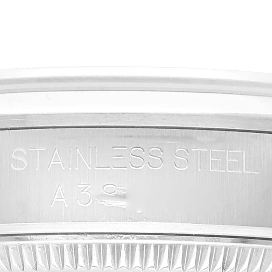 The image shows a close-up of the case back edge for a Mid-Size Rolex watch, inscribed with "STAINLESS STEEL" and a partial serial number.