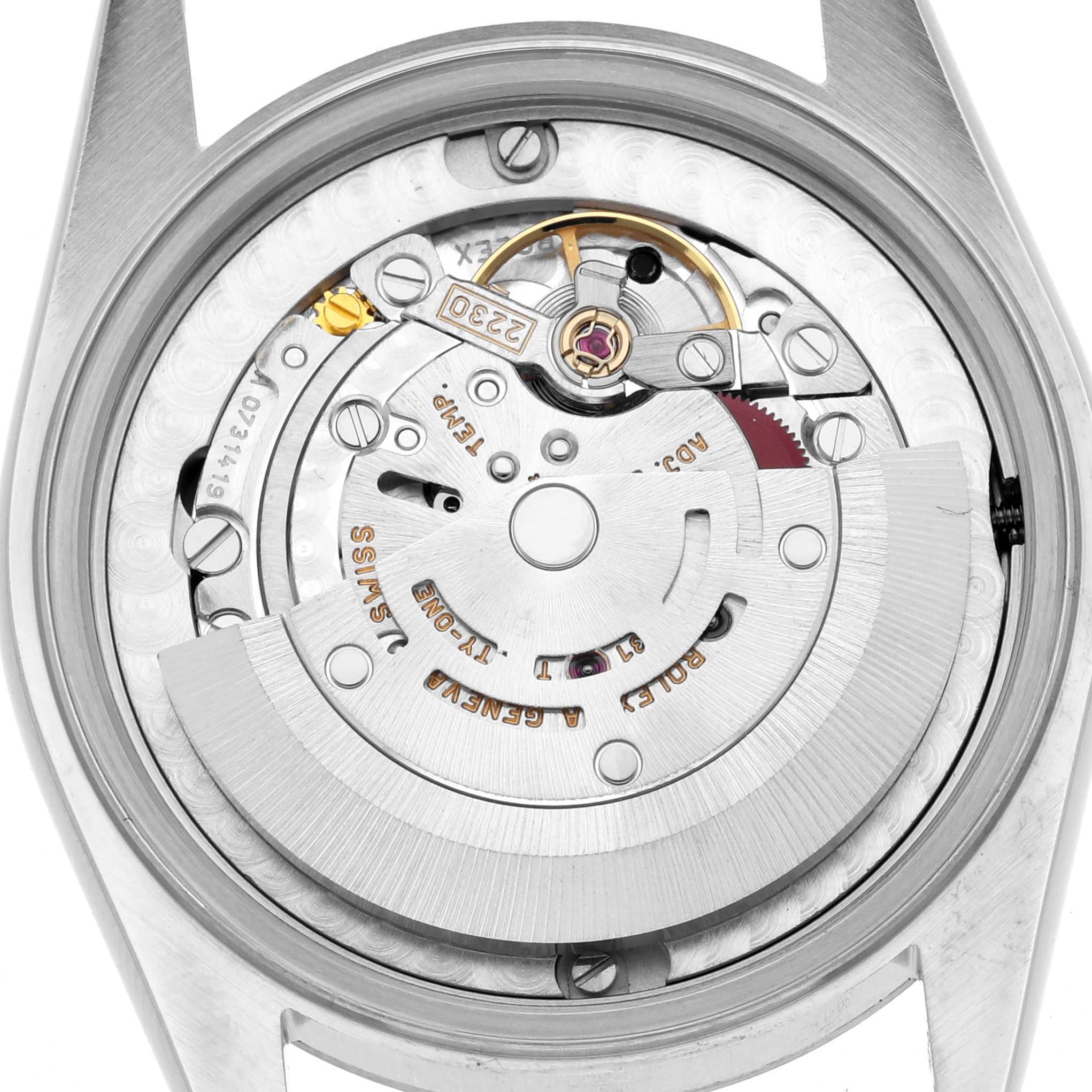 The image shows the back view of the Rolex Mid-Size 77080 Women's Stainless Steel Black Dial watch, displaying its internal mechanical movement components.