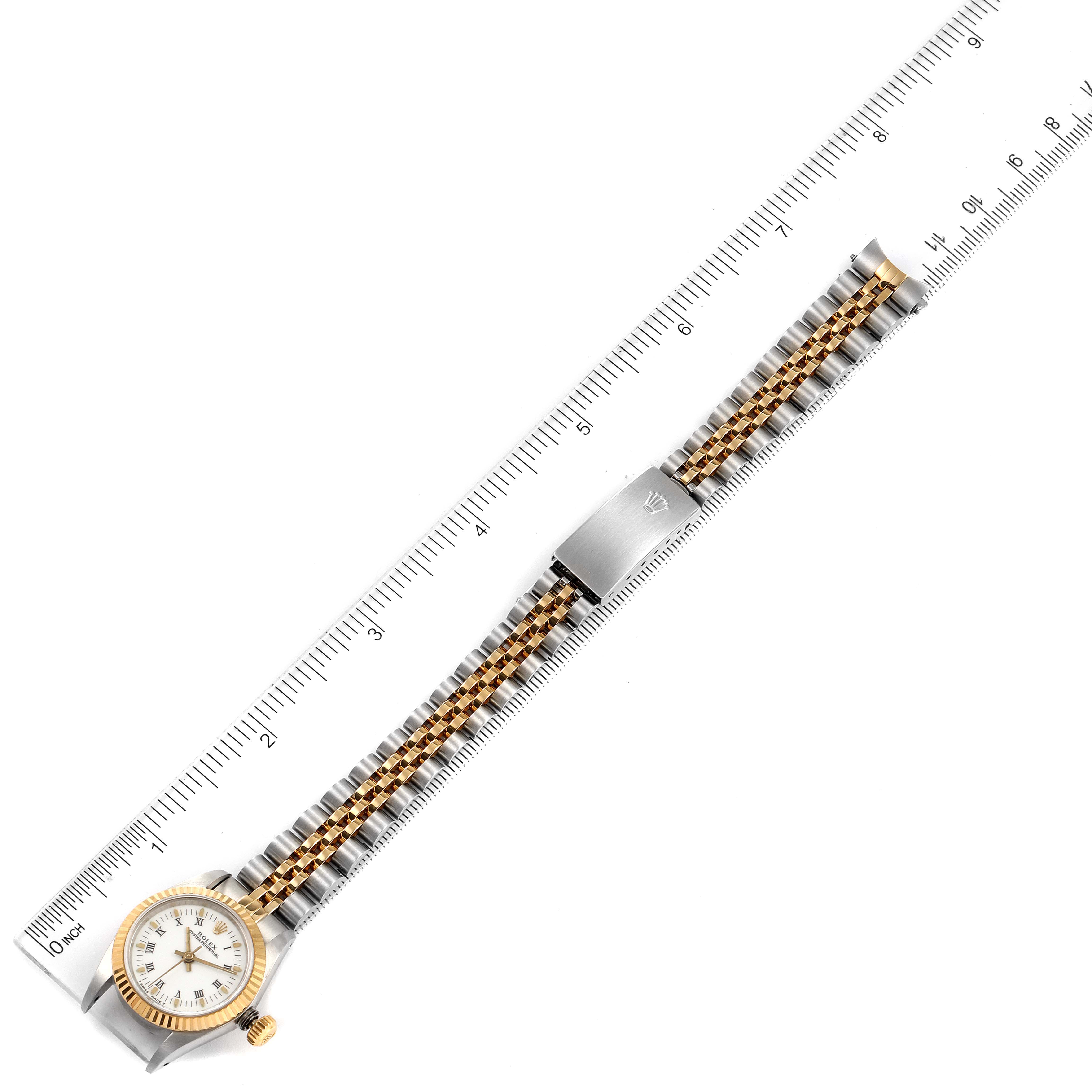 The Rolex Oyster Perpetual 67193 Women's Steel and Gold (two tone) White Dial 67193 Women's Steel and Gold (two tone) White Dial watch is shown in a top-down angle, displaying its face, bezel, crown, and full bracelet with a measurement scale.