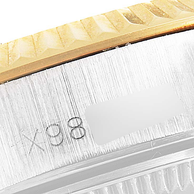 The image shows a close-up of the bezel and case side of a Rolex Oyster Perpetual 67193 Women's Steel and Gold (two tone) White Dial 67193 Women's Steel and Gold (two tone) White Dial watch, focusing on the etchings.