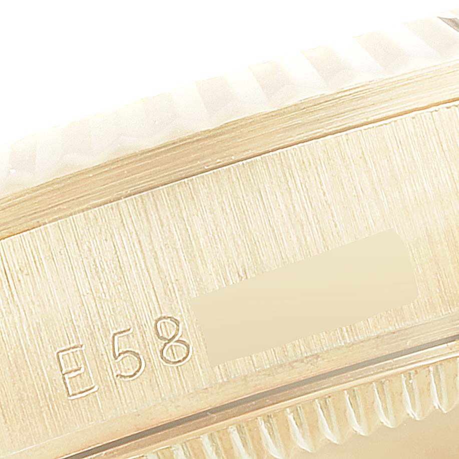 The image shows a close-up of the engraved side and fluted bezel of a Rolex President 68278 Women
s Yellow Gold Champagne Dial 68278 Women
s Yellow Gold Champagne Dial model watch.