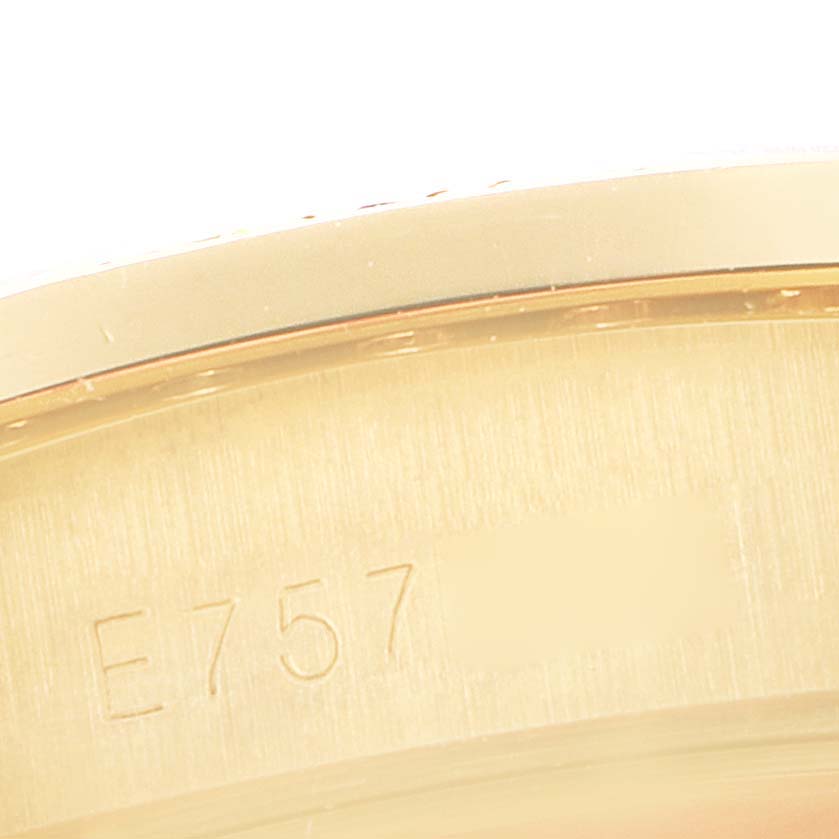 This image shows a close-up of the side of a Rolex President 18388 Men's Yellow Gold Champagne Dial 18388 Men's Yellow Gold Champagne Dial model watch, highlighting the engraved serial number.