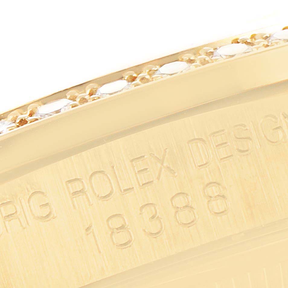 This close-up image shows part of the bezel and case back of a Rolex President 18388 Men's Yellow Gold Champagne Dial 18388 Men's Yellow Gold Champagne Dial model, revealing its engraved design details.