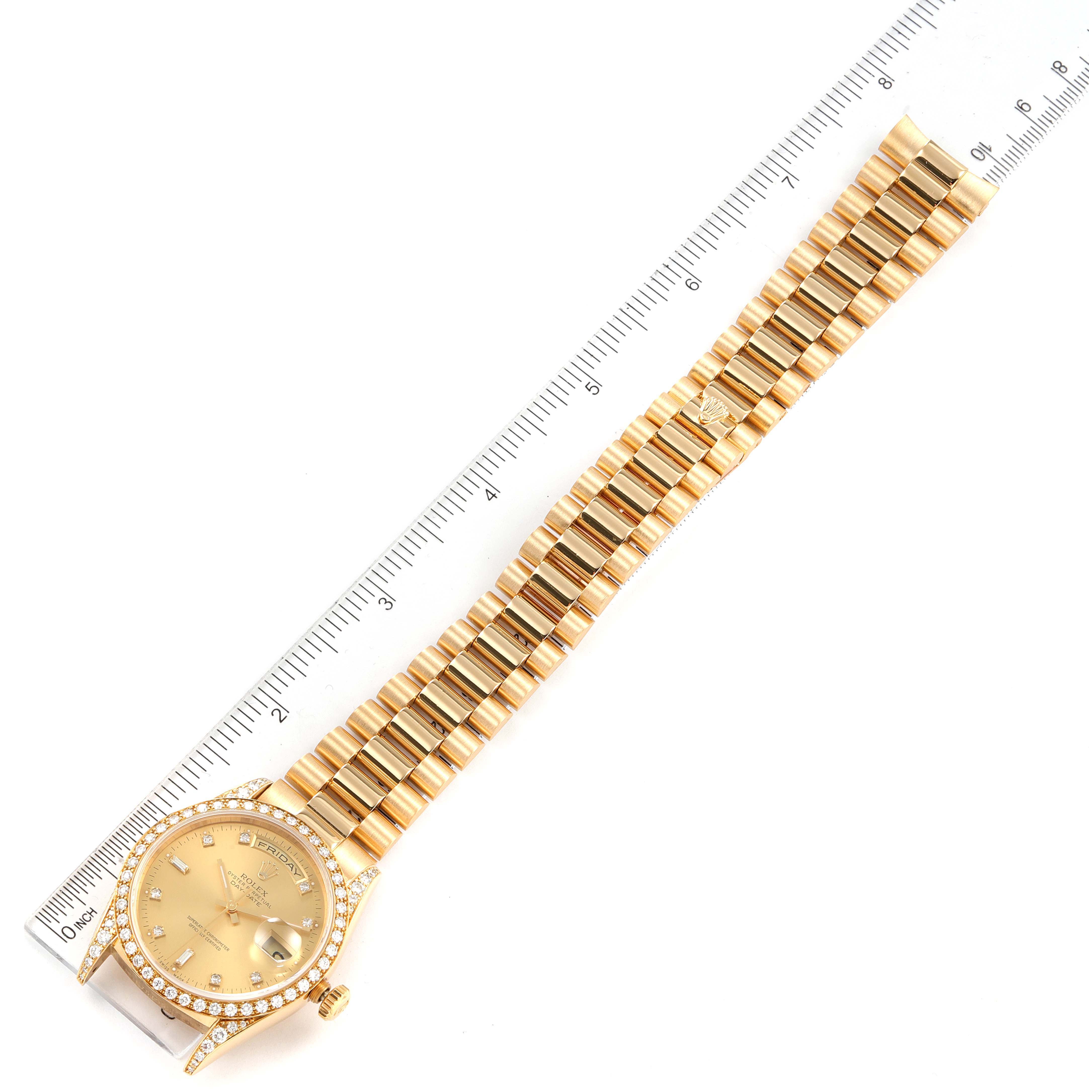 The image shows the President model Rolex watch laid flat, displaying its full length and bracelet alongside a ruler.